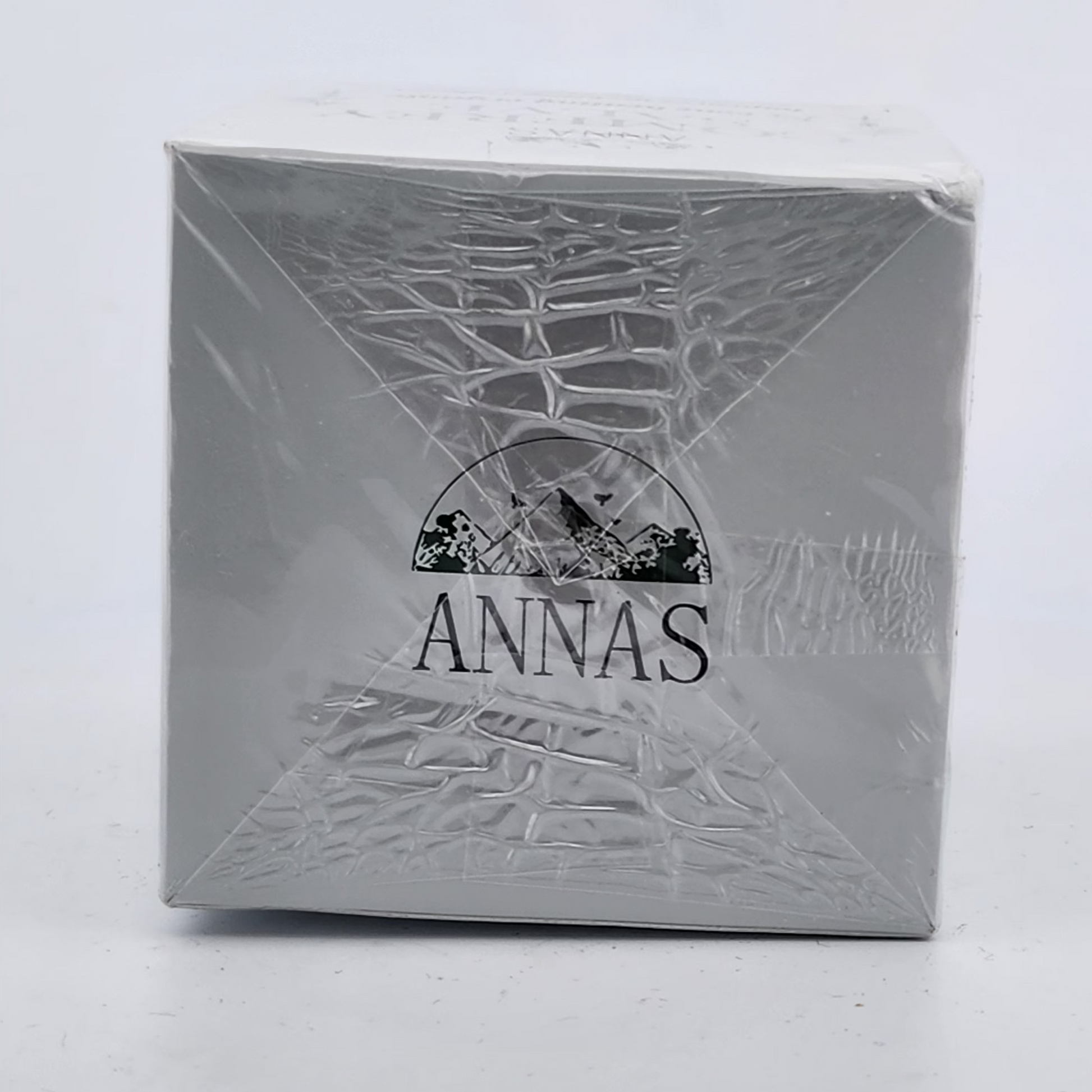 Silver box with 'ANNAS' branding on a white background