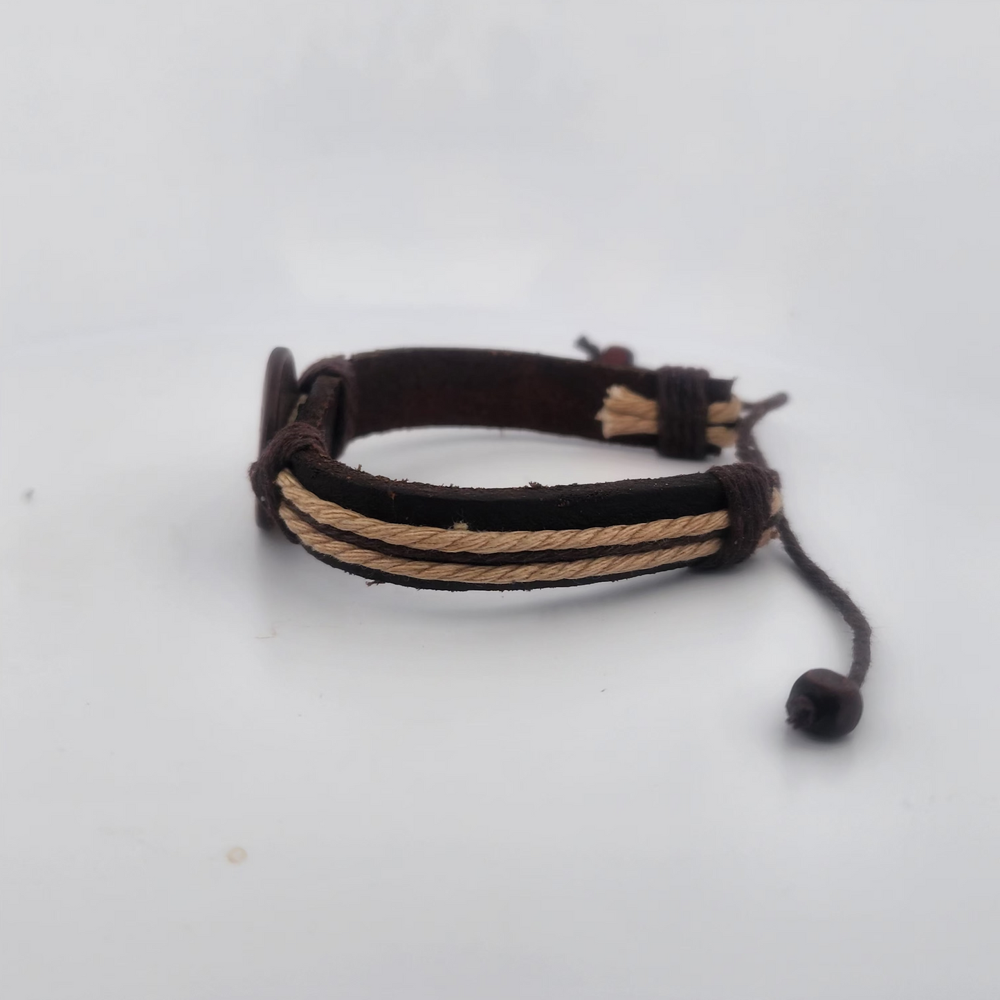 Bracelet with brown and beige braided cord on a white background