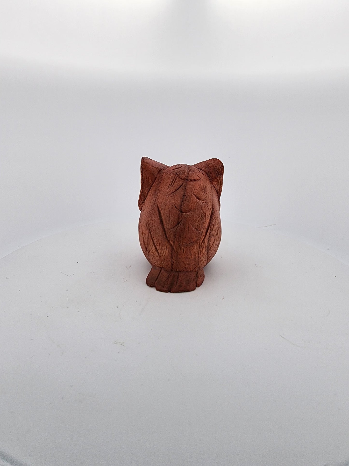 Wooden owl figurine on a white background