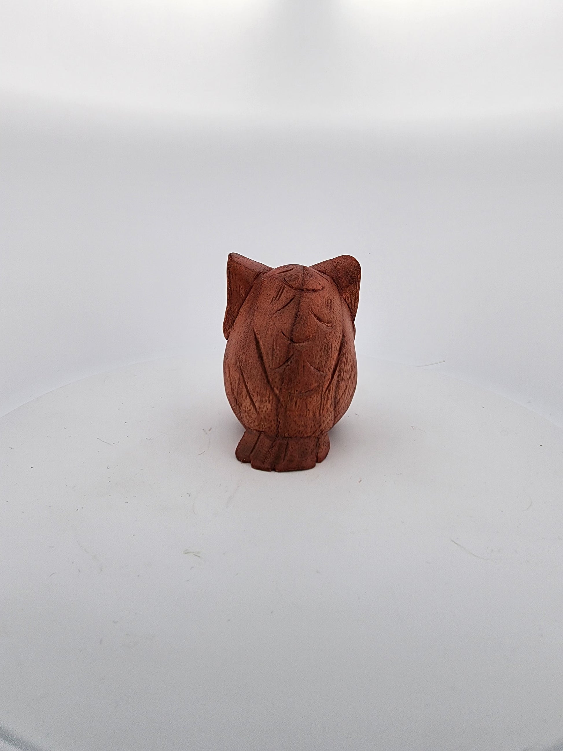 Wooden owl figurine on a white background