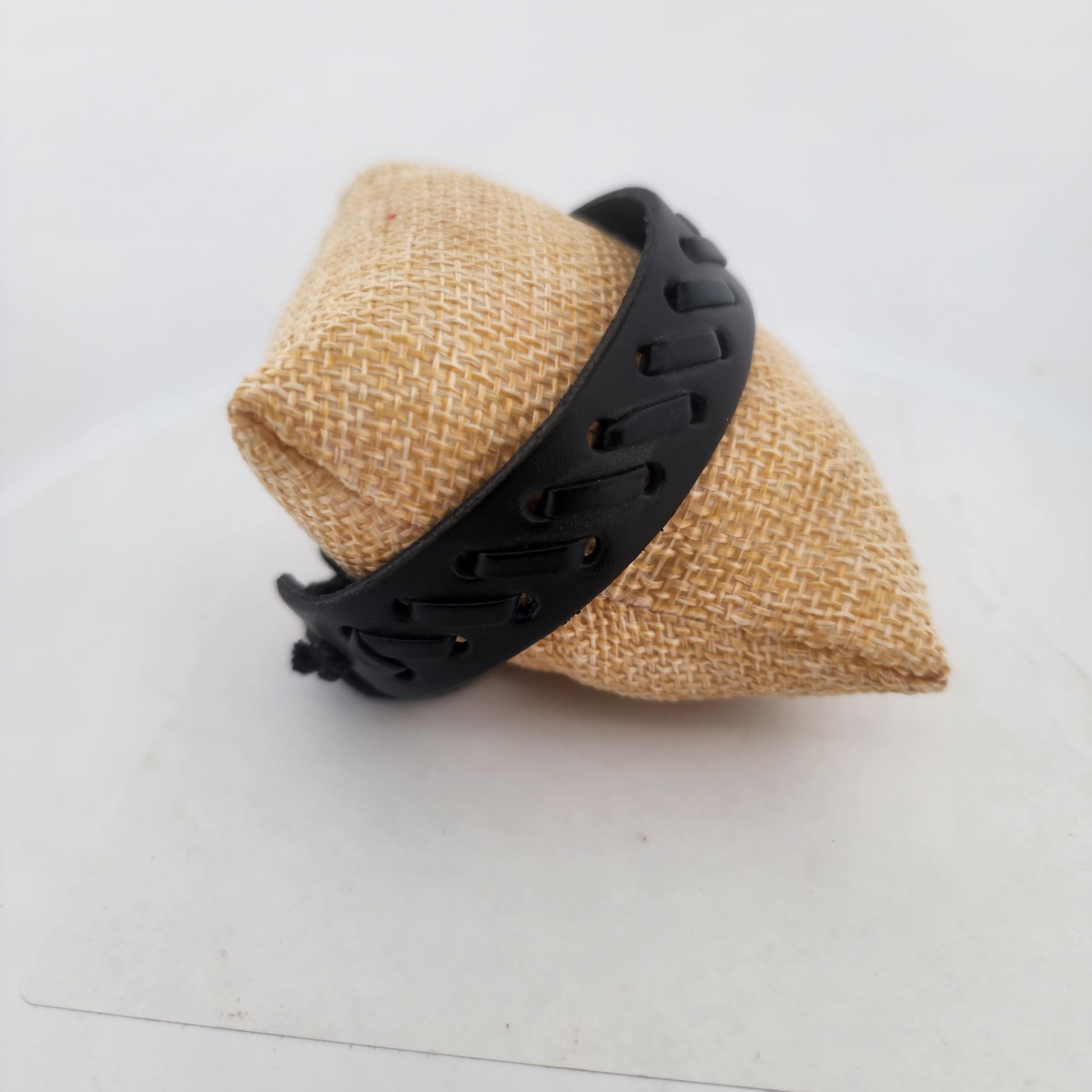 Beige dog cone with black plastic holder on a white surface