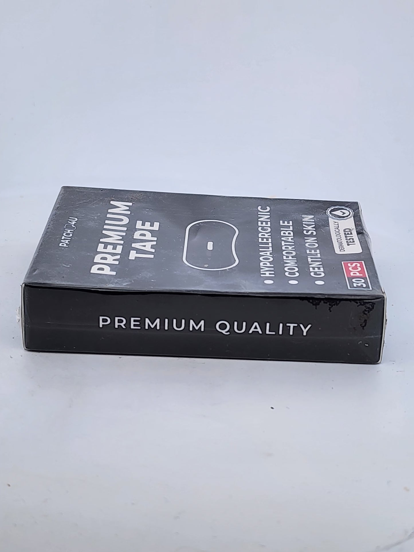 Box of premium tape on a light gray background