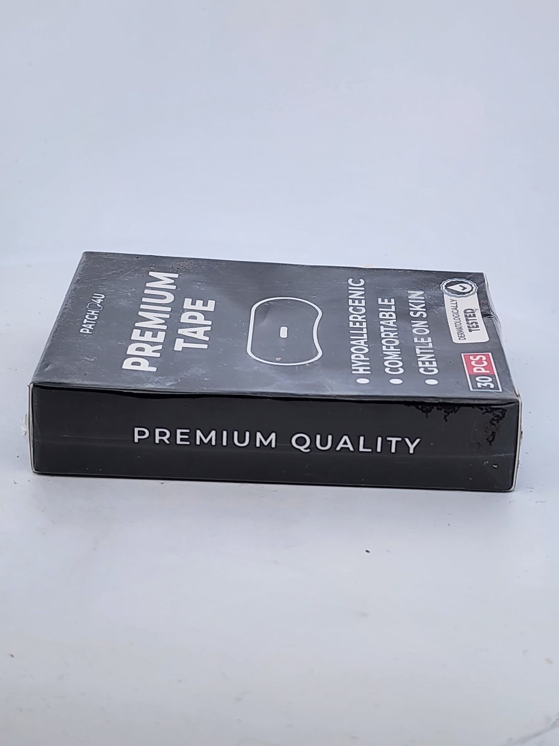Box of premium tape on a light gray background
