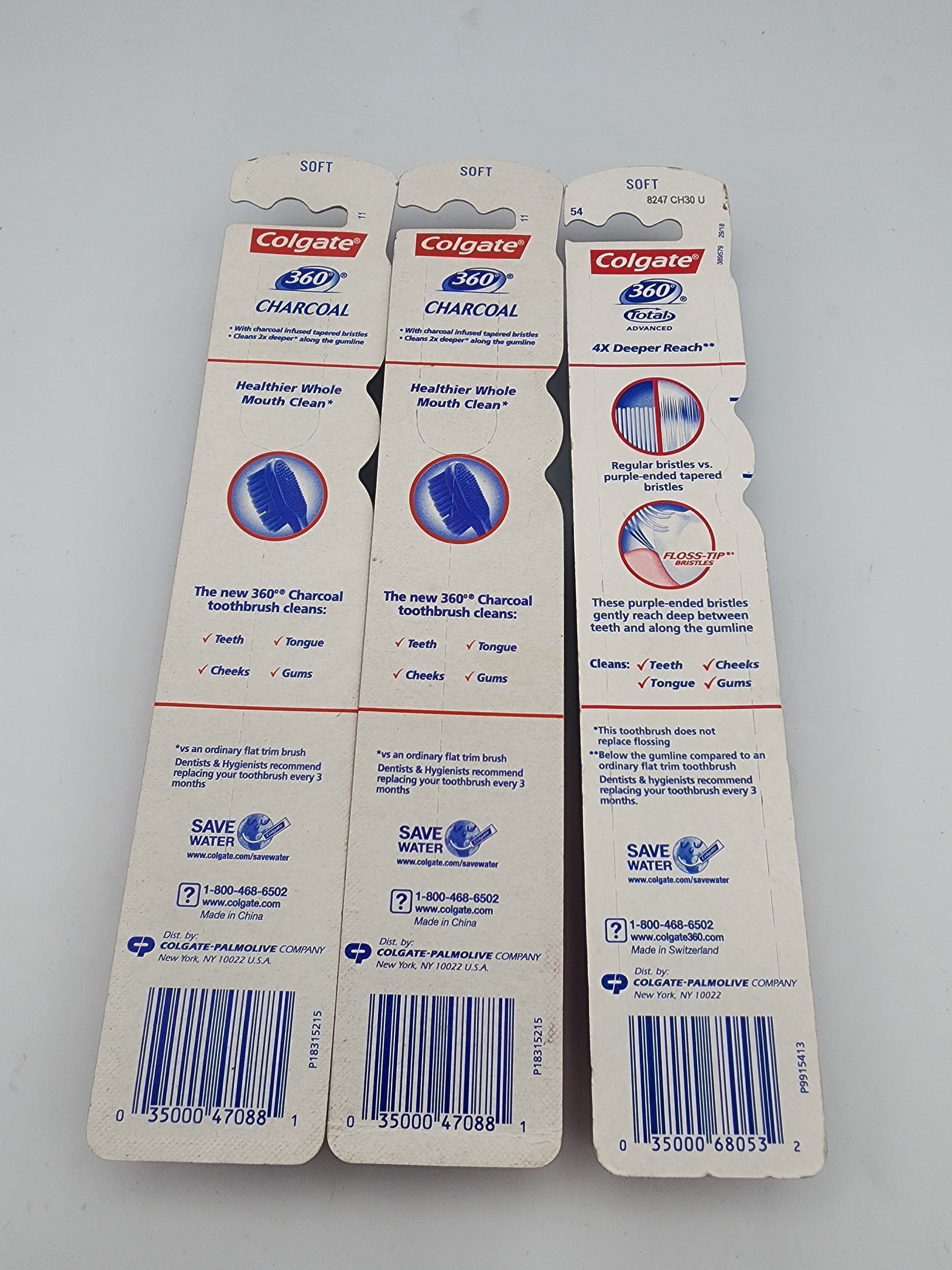 Three Colgate 360 Charcoal toothbrush heads packaging on a gray background