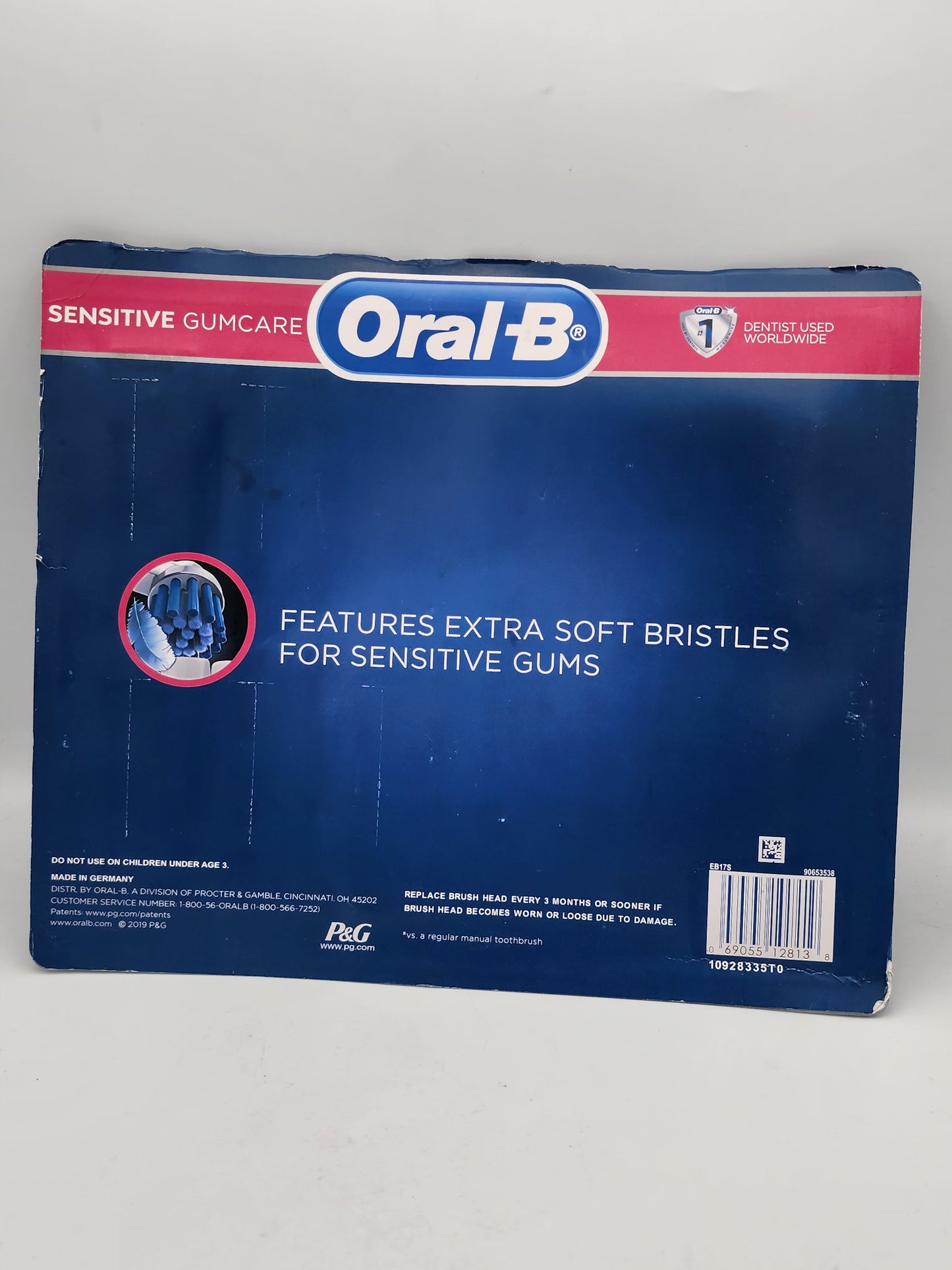 Oral-B toothbrush packaging with blue and red design on a white background