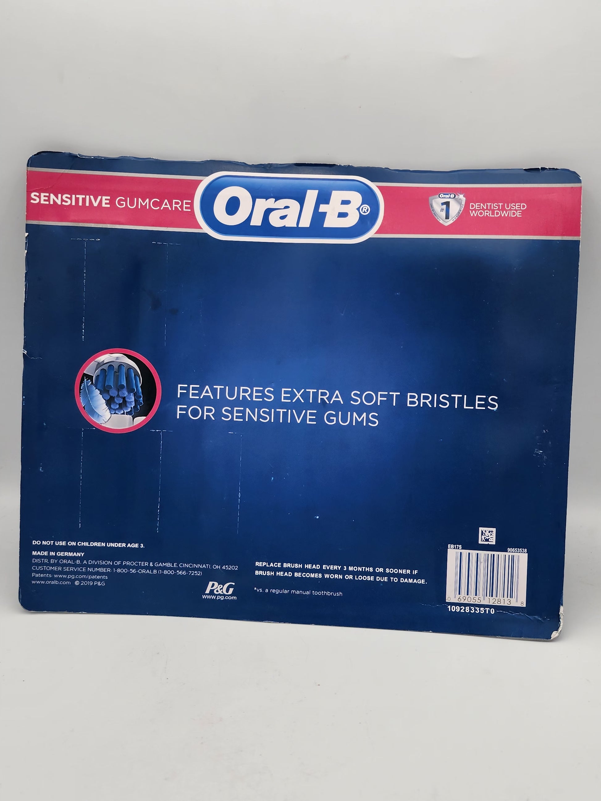 Oral-B toothbrush packaging with blue and red design on a white background