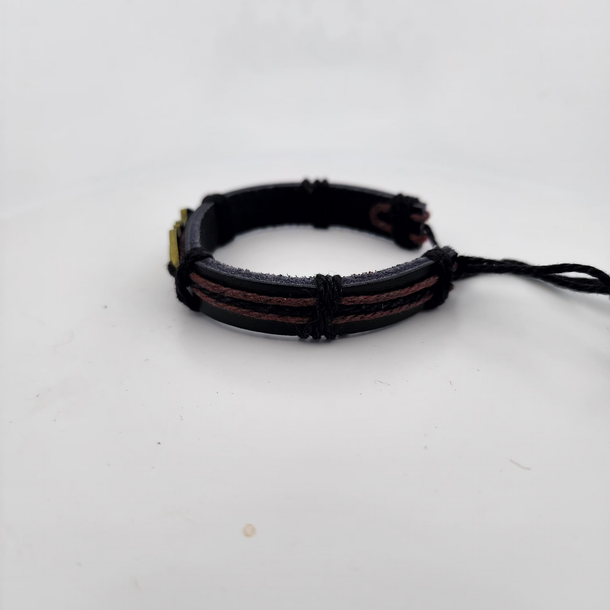 Black braided bracelet on a white background