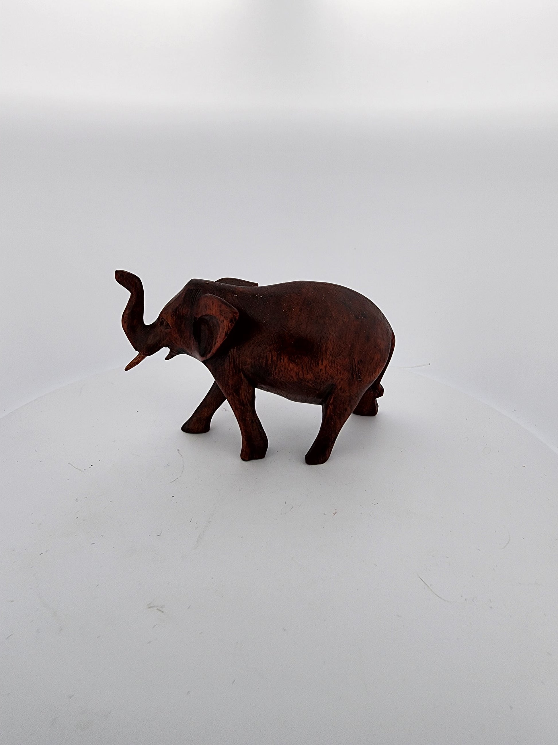 Bronze elephant figurine on a white background