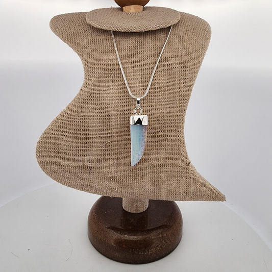 Necklace on a mannequin bust with a plain background