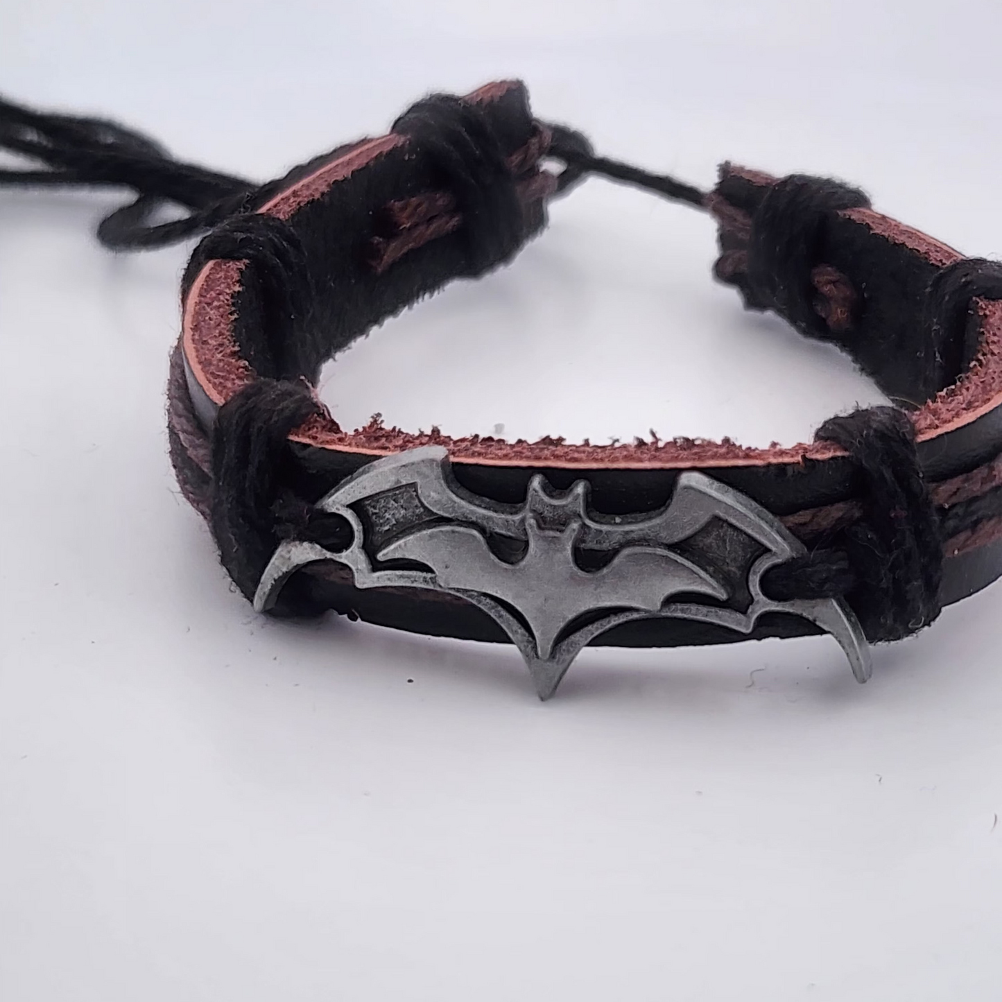 Bracelet with bat-shaped clasp on a white background