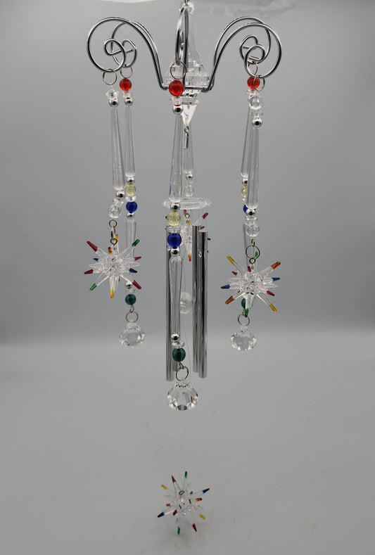 Decorative hanging crystal with colorful beads on a gray background