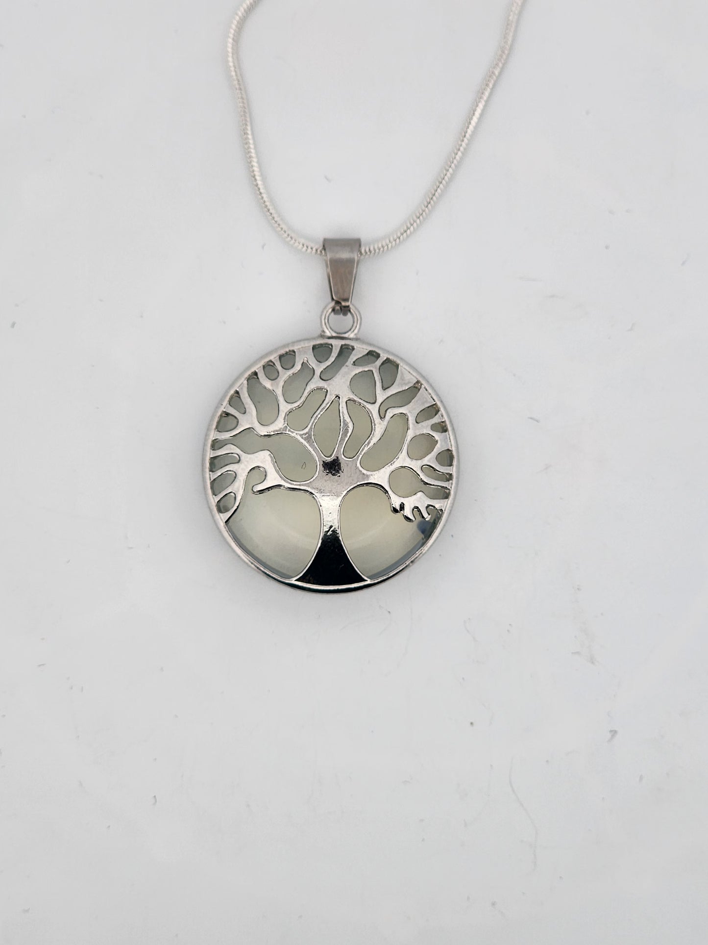 Silver tree of life pendant on a white background