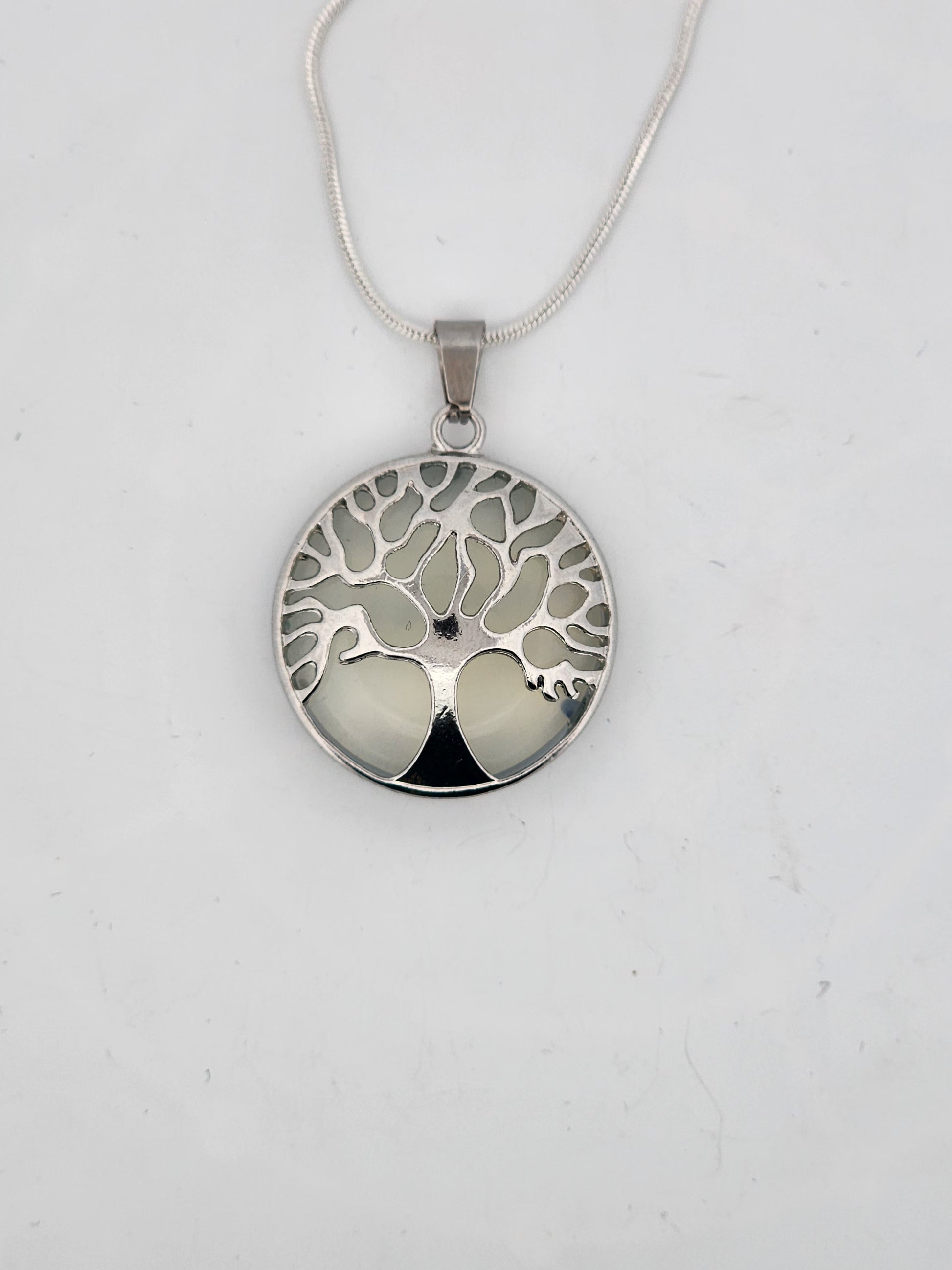 Silver tree of life pendant on a white background