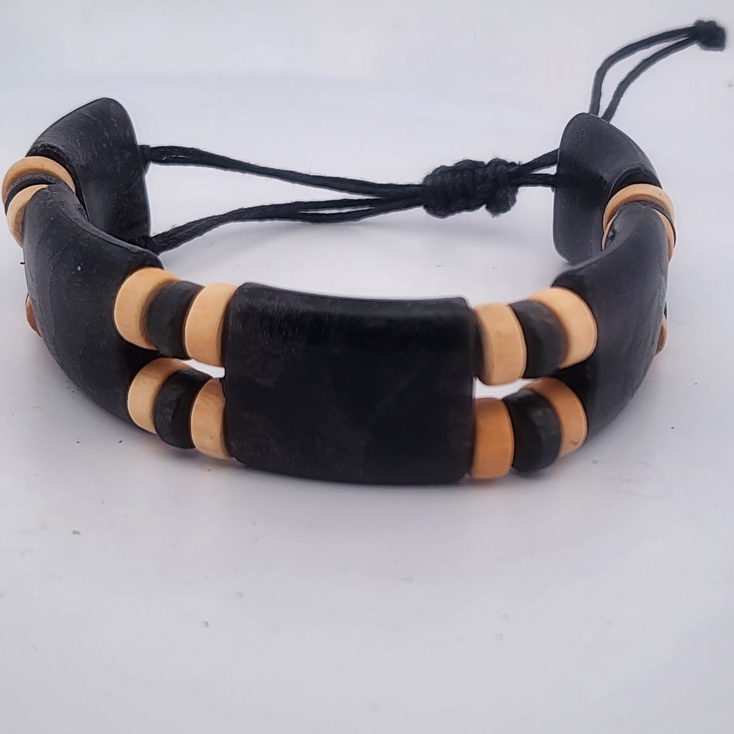 Black and beige bracelet on a white background