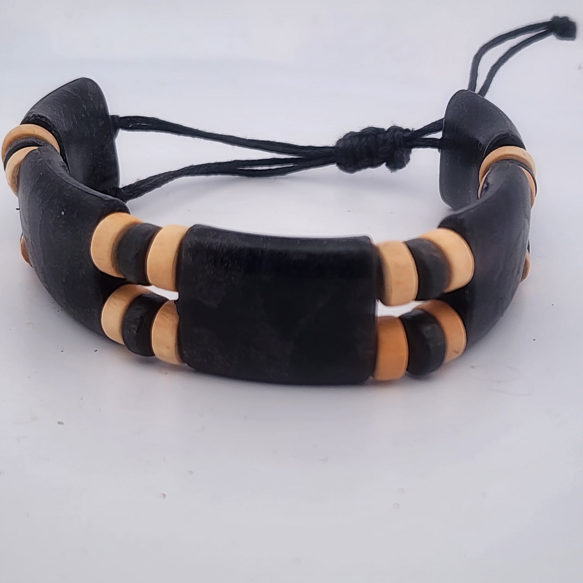 Black and beige bracelet on a white background