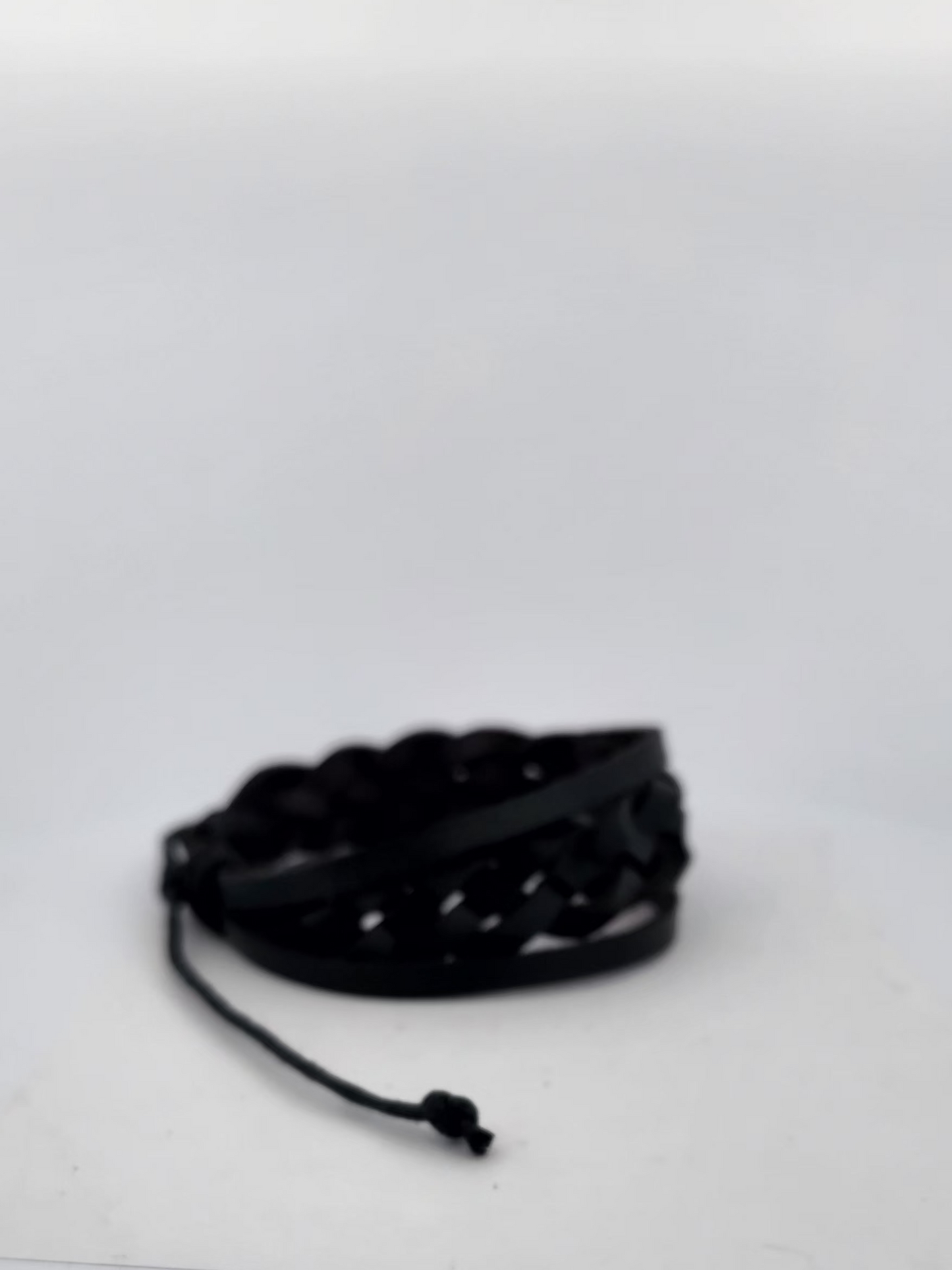 Black bracelet on a white surface