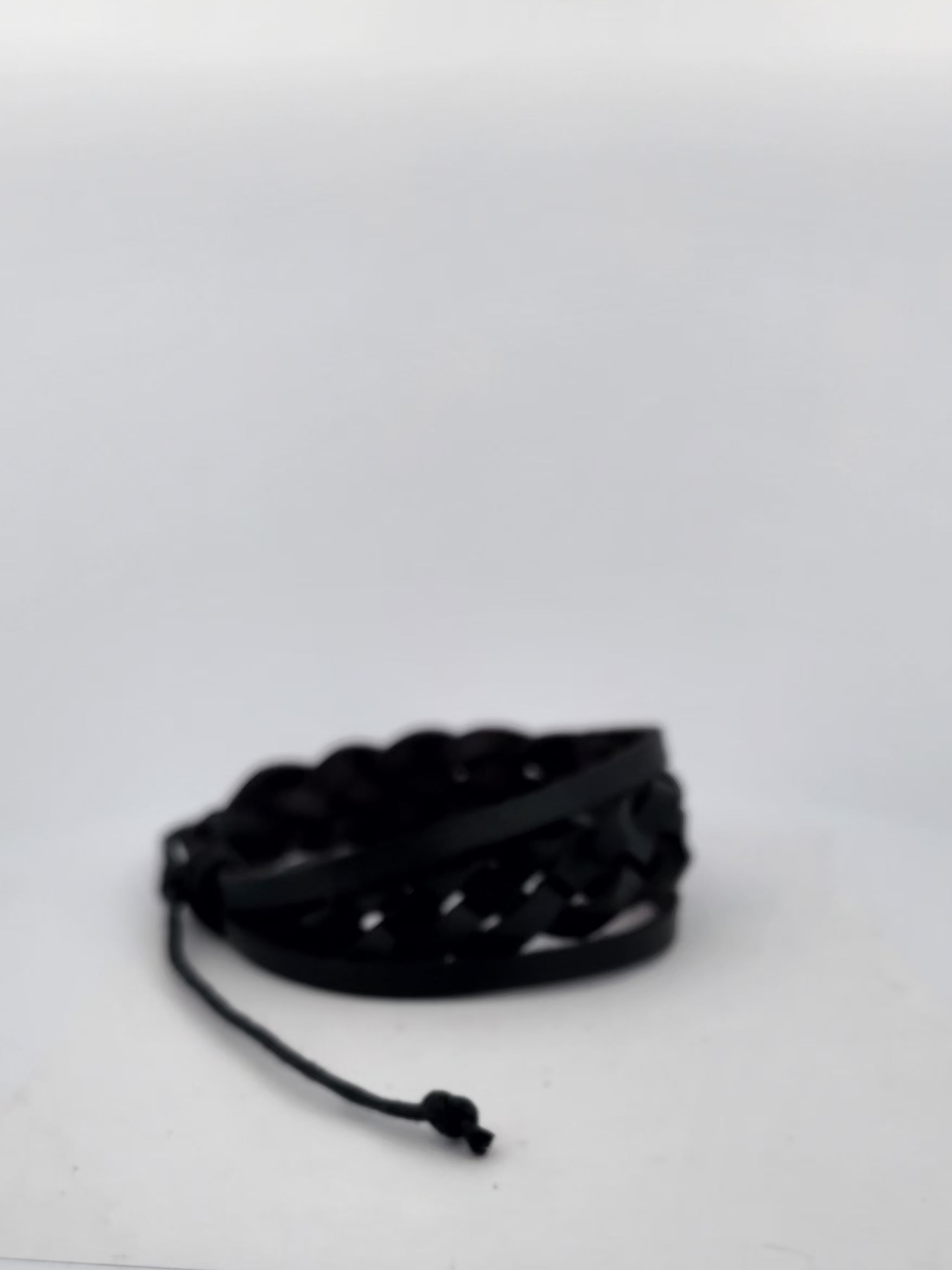 Black bracelet on a white surface