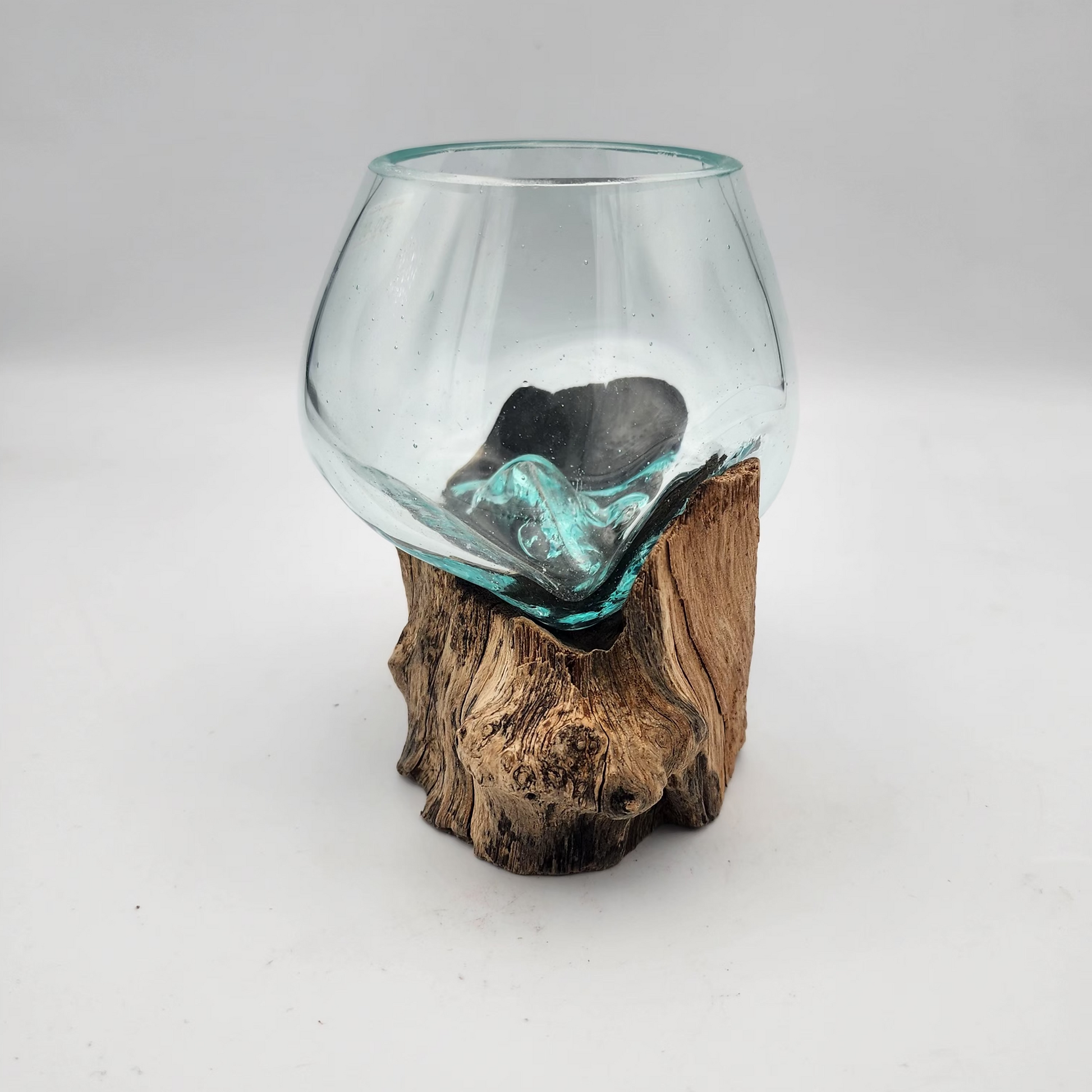 Glass vase with a natural wood base on a white background
