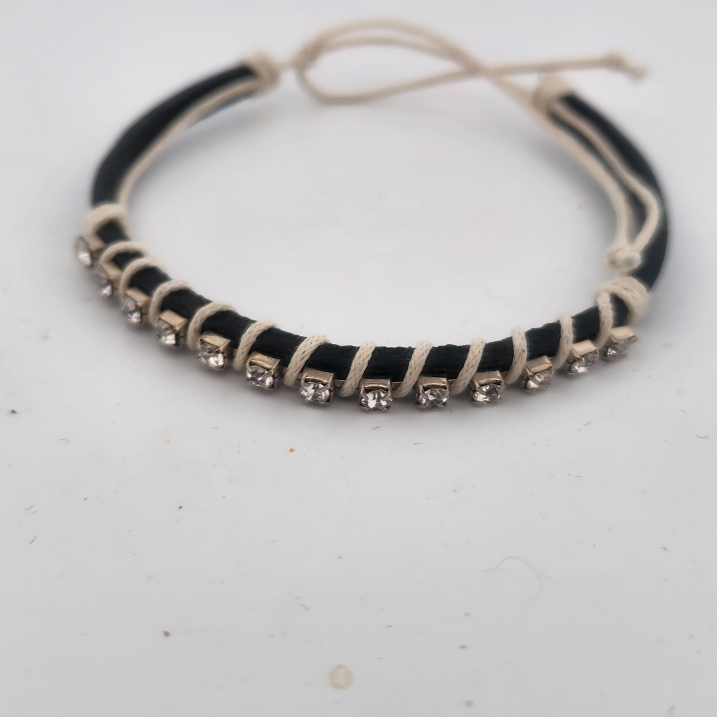Black and white beaded choker necklace on a light gray background