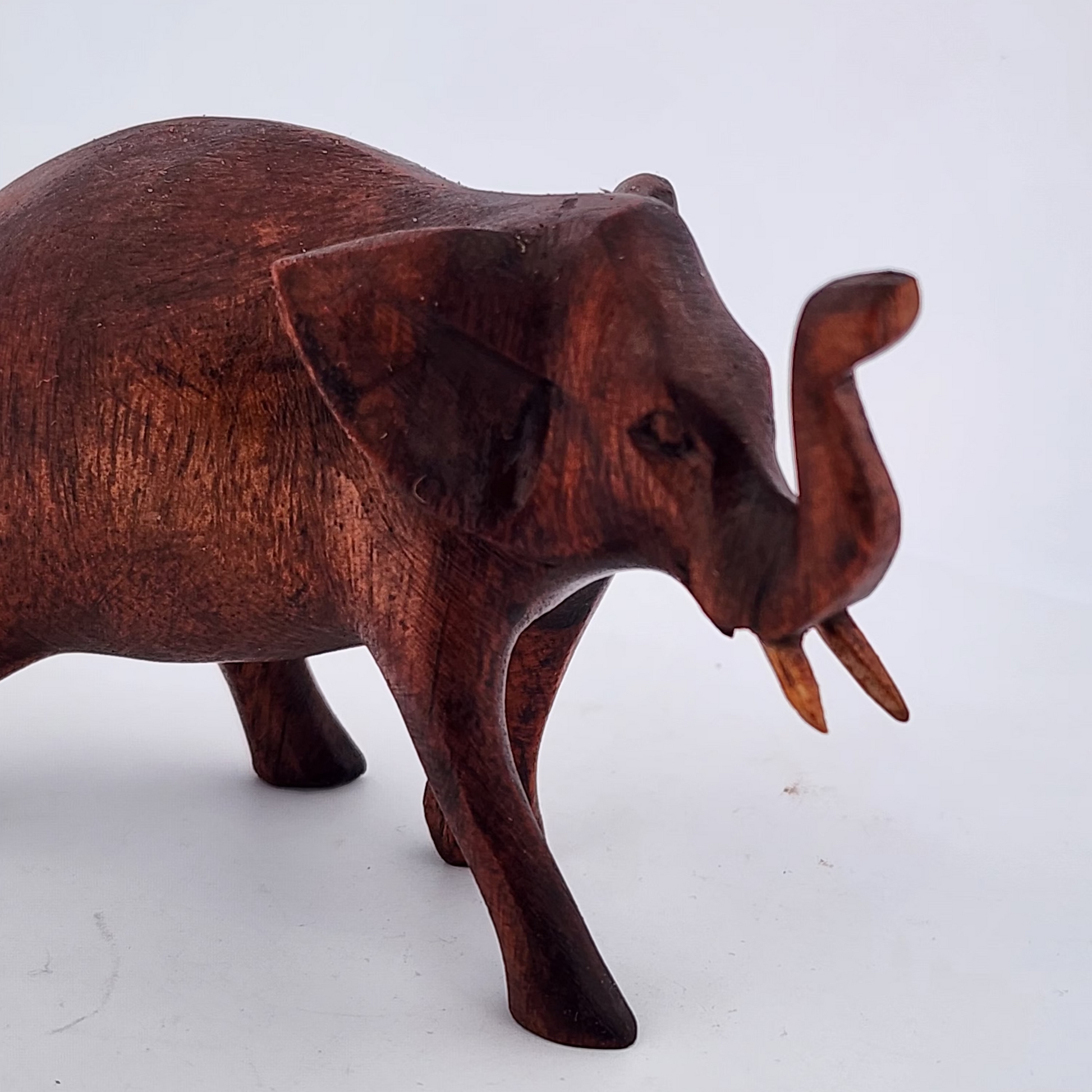 Wooden elephant figurine on a white background