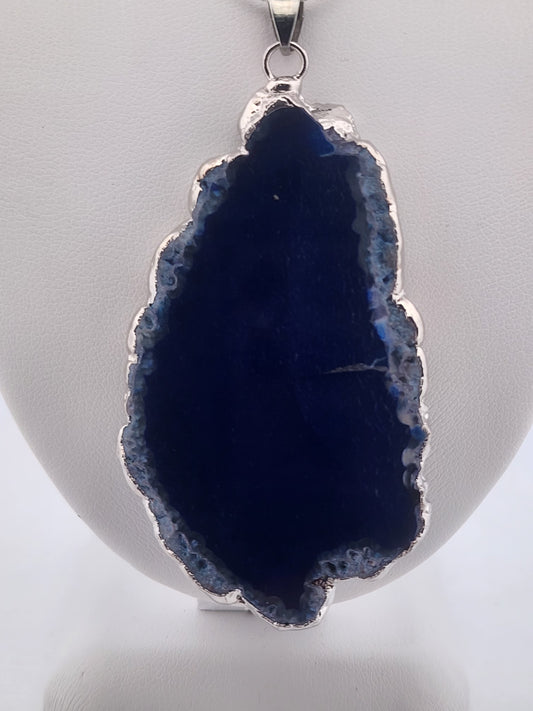 Blue geode pendant on a white background