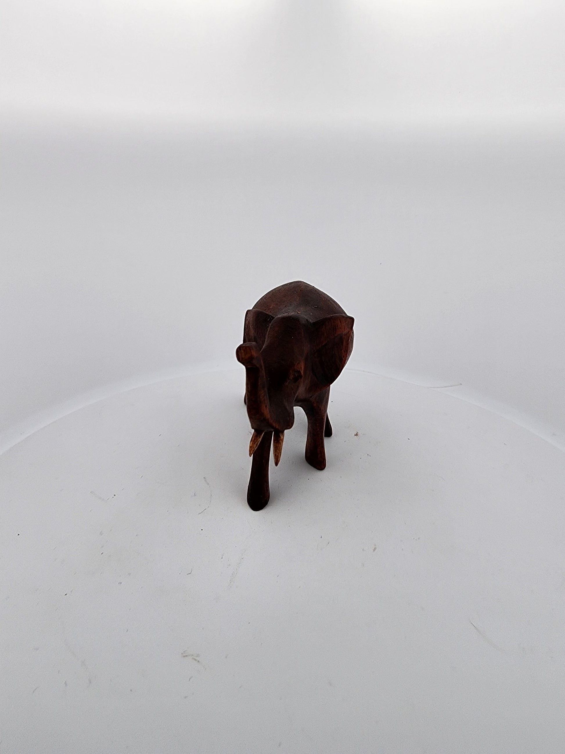 Small brown figurine on a white background