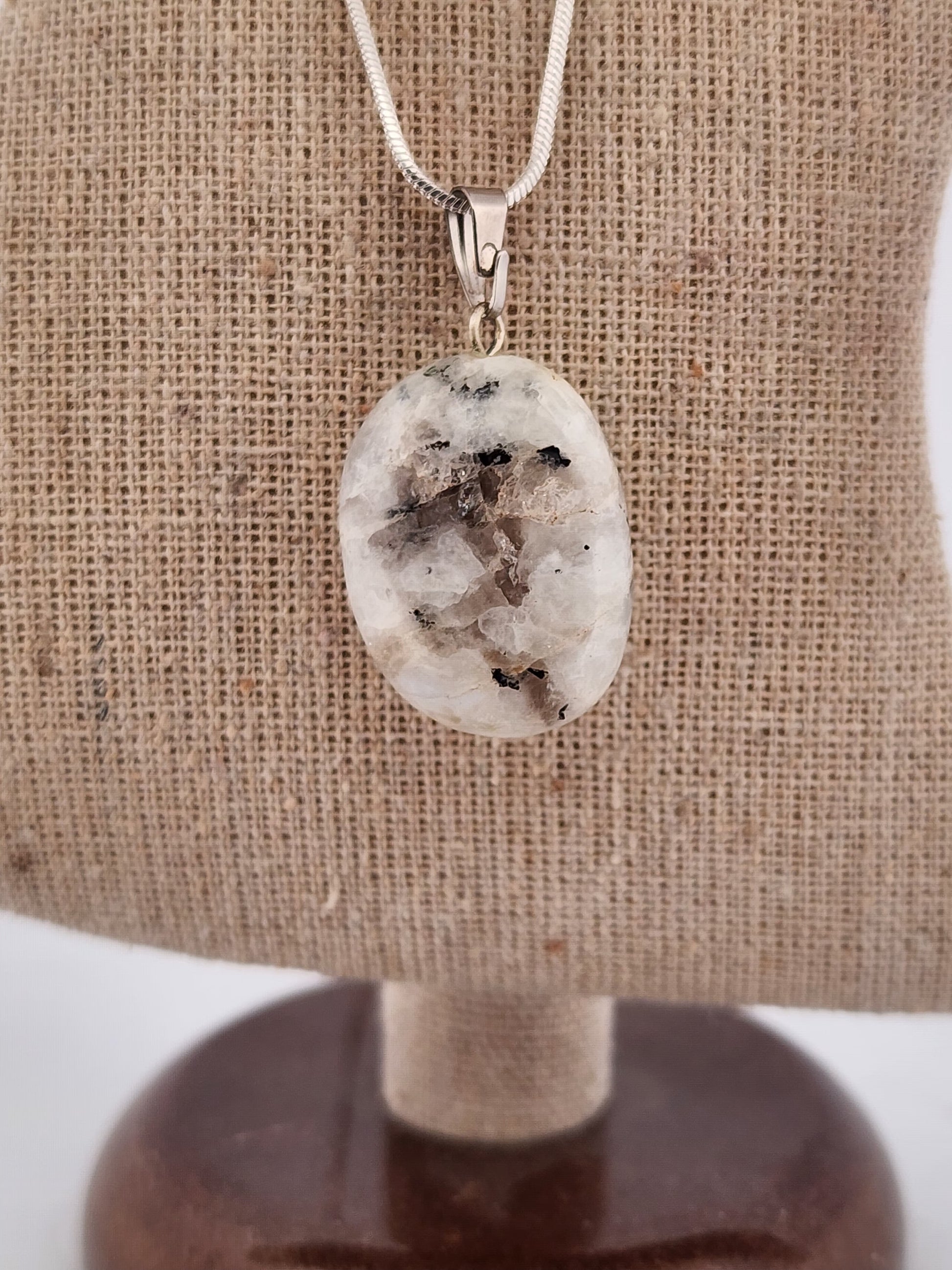 Necklace with a pendant on a brown fabric background