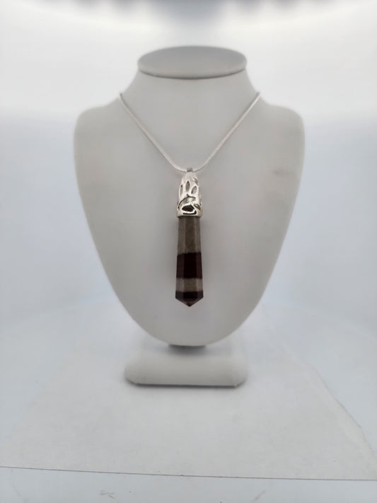 Necklace with a pendant on a mannequin bust against a white background