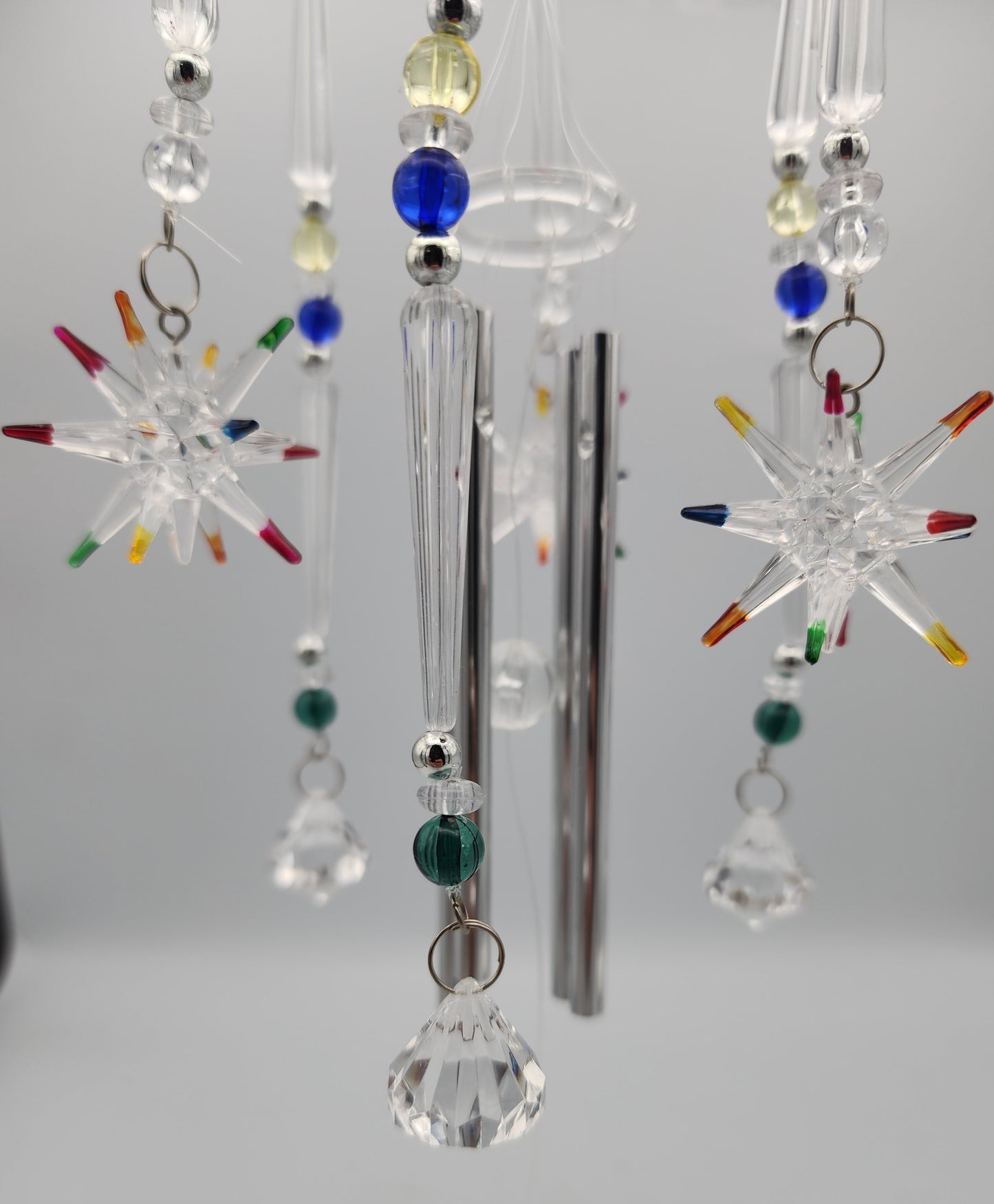 Crystal mobile with colorful beads on a plain background