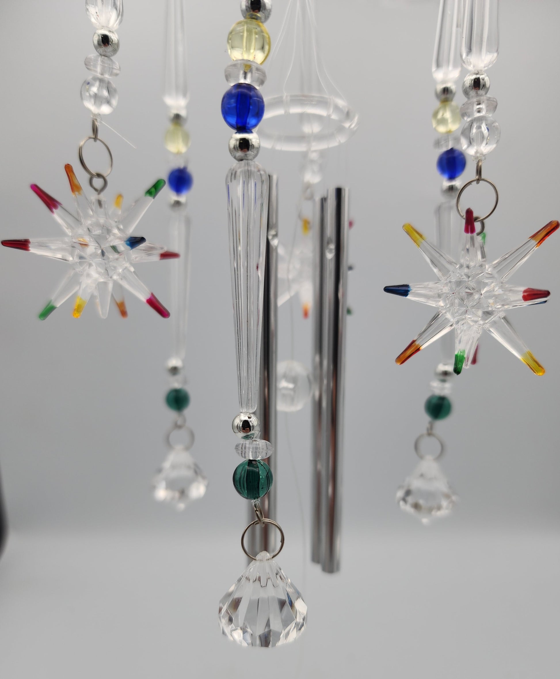 Crystal mobile with colorful beads on a plain background