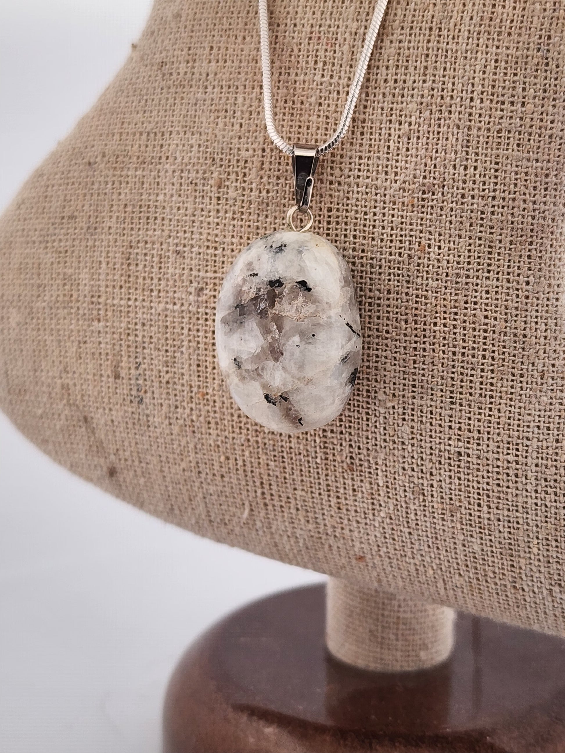 Necklace with a pendant on a beige fabric background