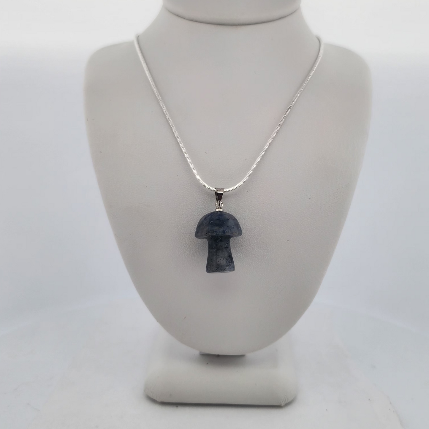 Necklace with a pendant on a mannequin bust against a white background