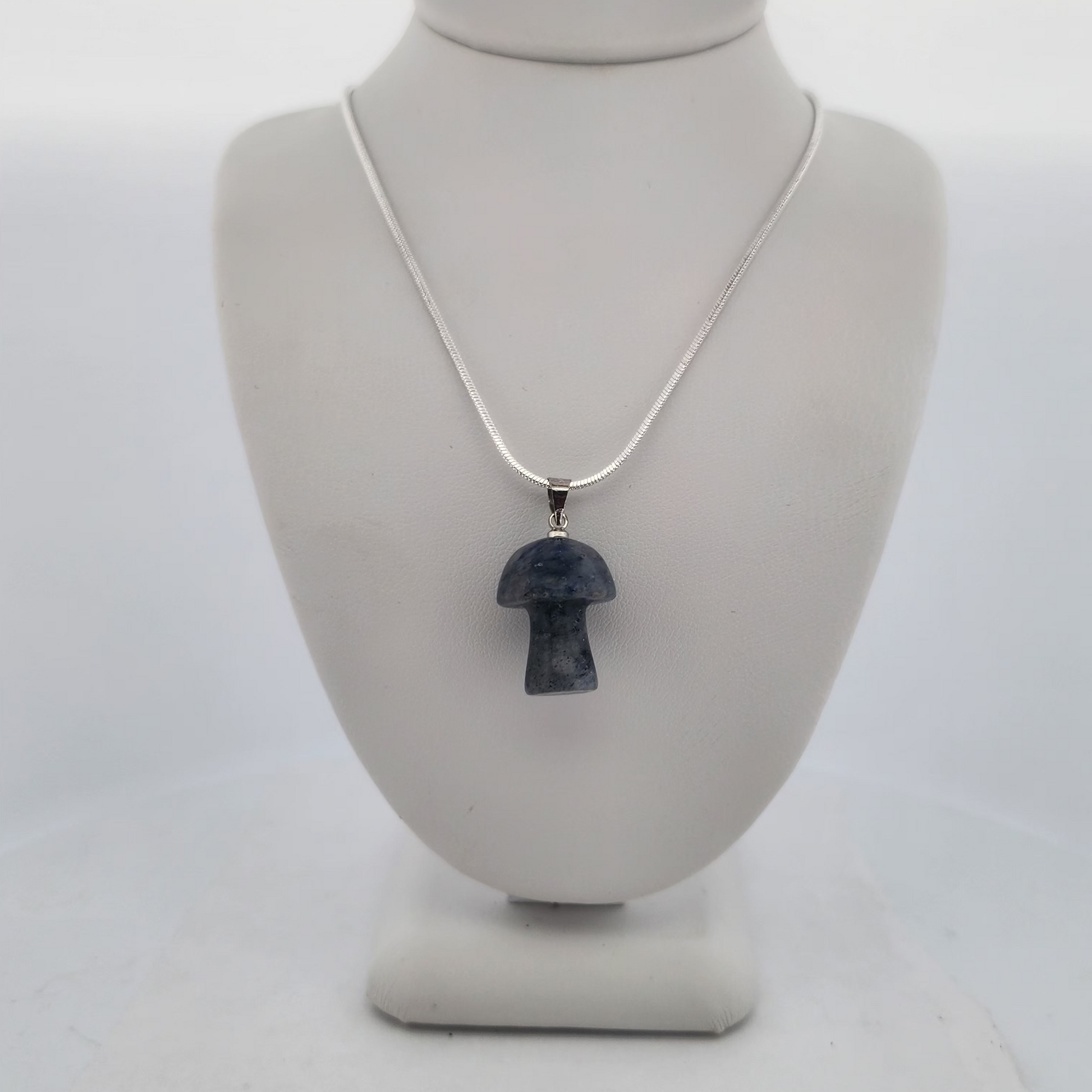 Necklace with a pendant on a mannequin bust against a white background