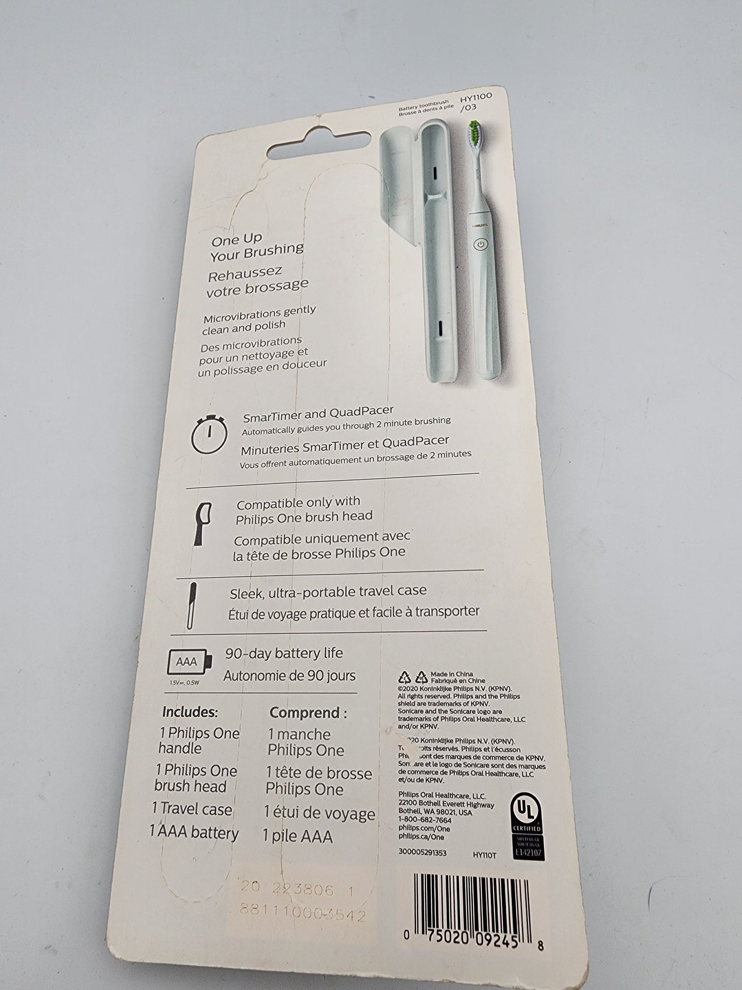 Back view of a Philips Sonicare electric toothbrush packaging on a gray background