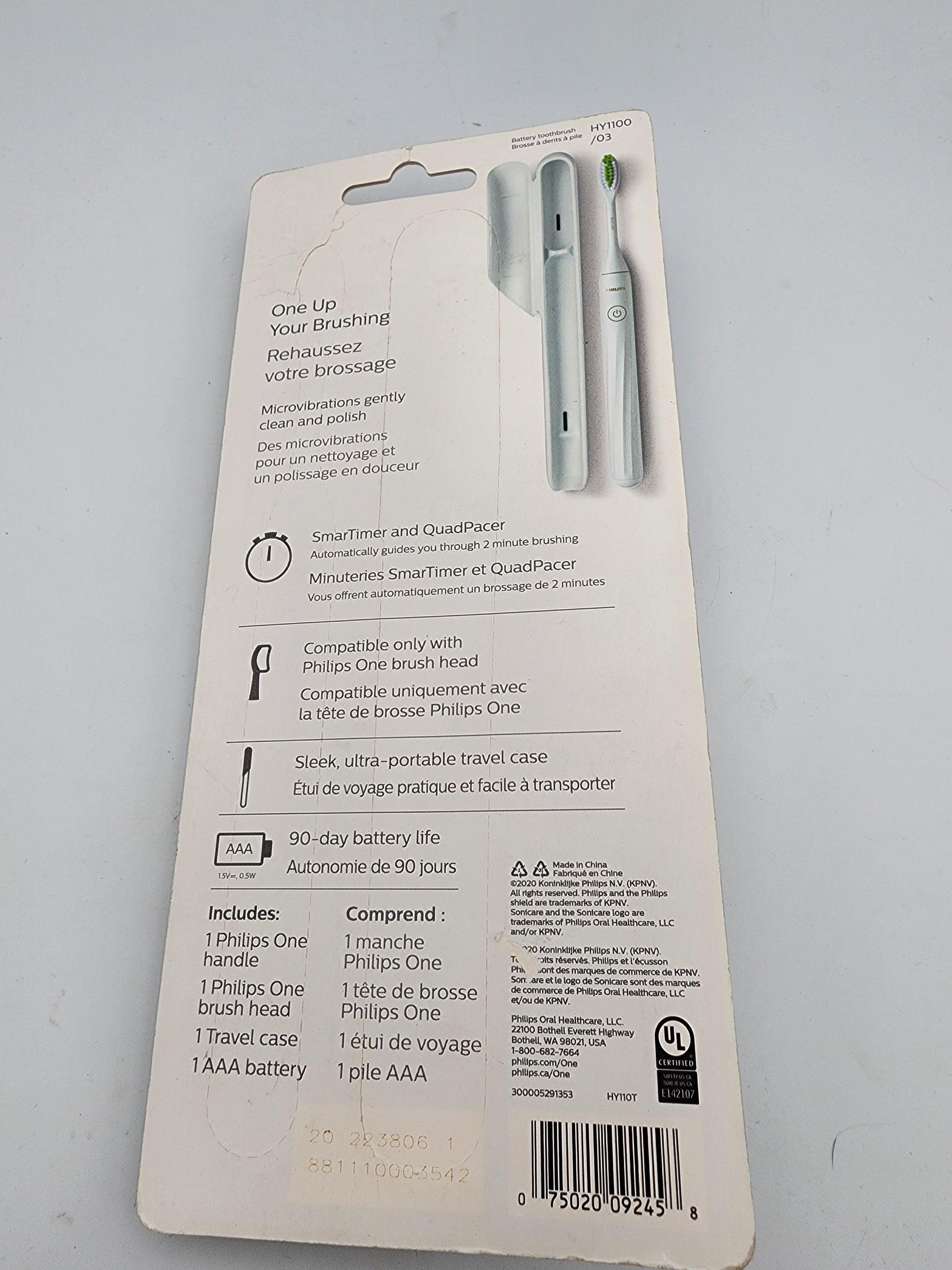 Back view of a Philips Sonicare electric toothbrush packaging on a gray background