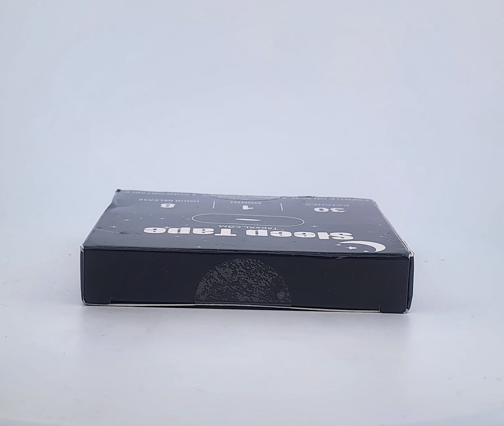 Black box with text on a white surface