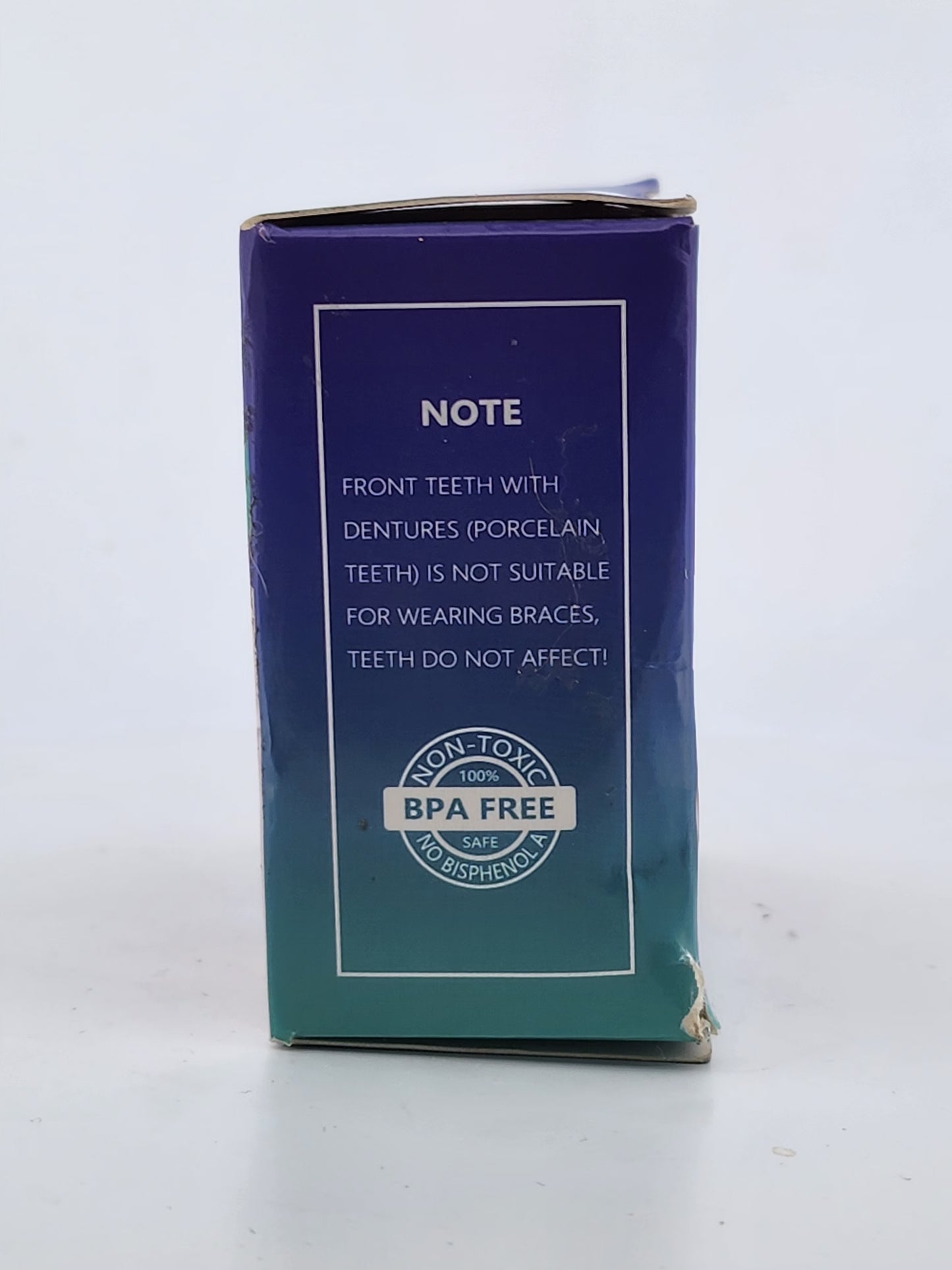 Blue dental product packaging with text and a logo on a white background