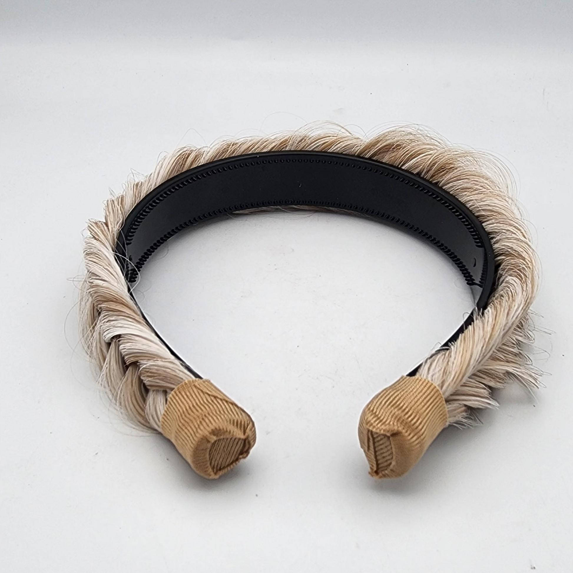 Headband with braided design on a white background
