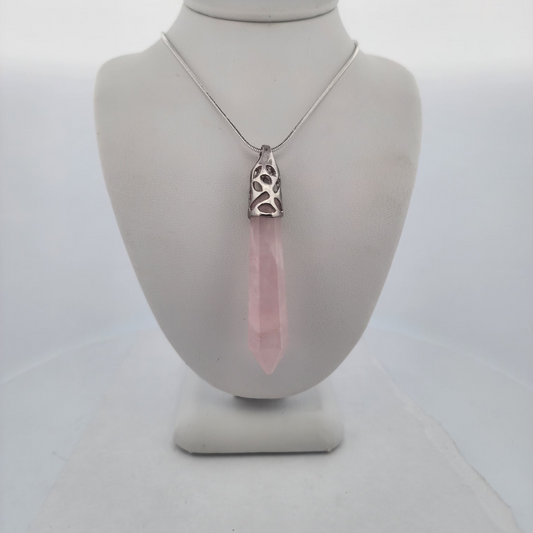 Necklace with a pink pendant on a mannequin bust against a white background