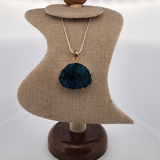 Necklace with a blue pom-pom pendant on a mannequin bust.