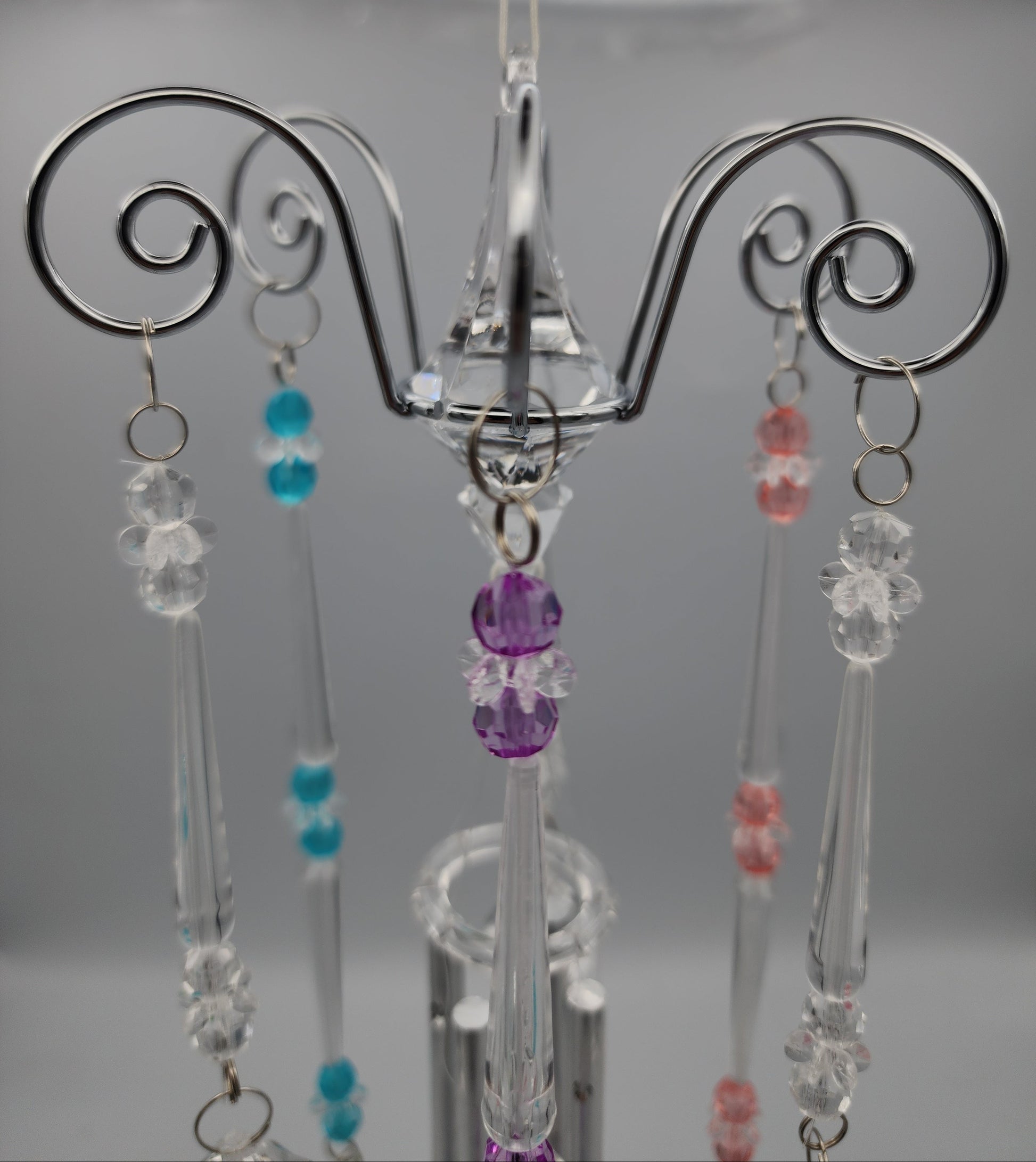 Decorative hanger with beads on a plain background