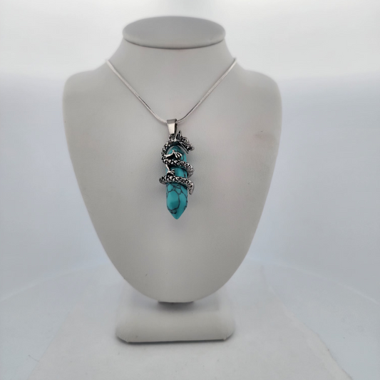 Turquoise pendant necklace on a mannequin bust against a white background