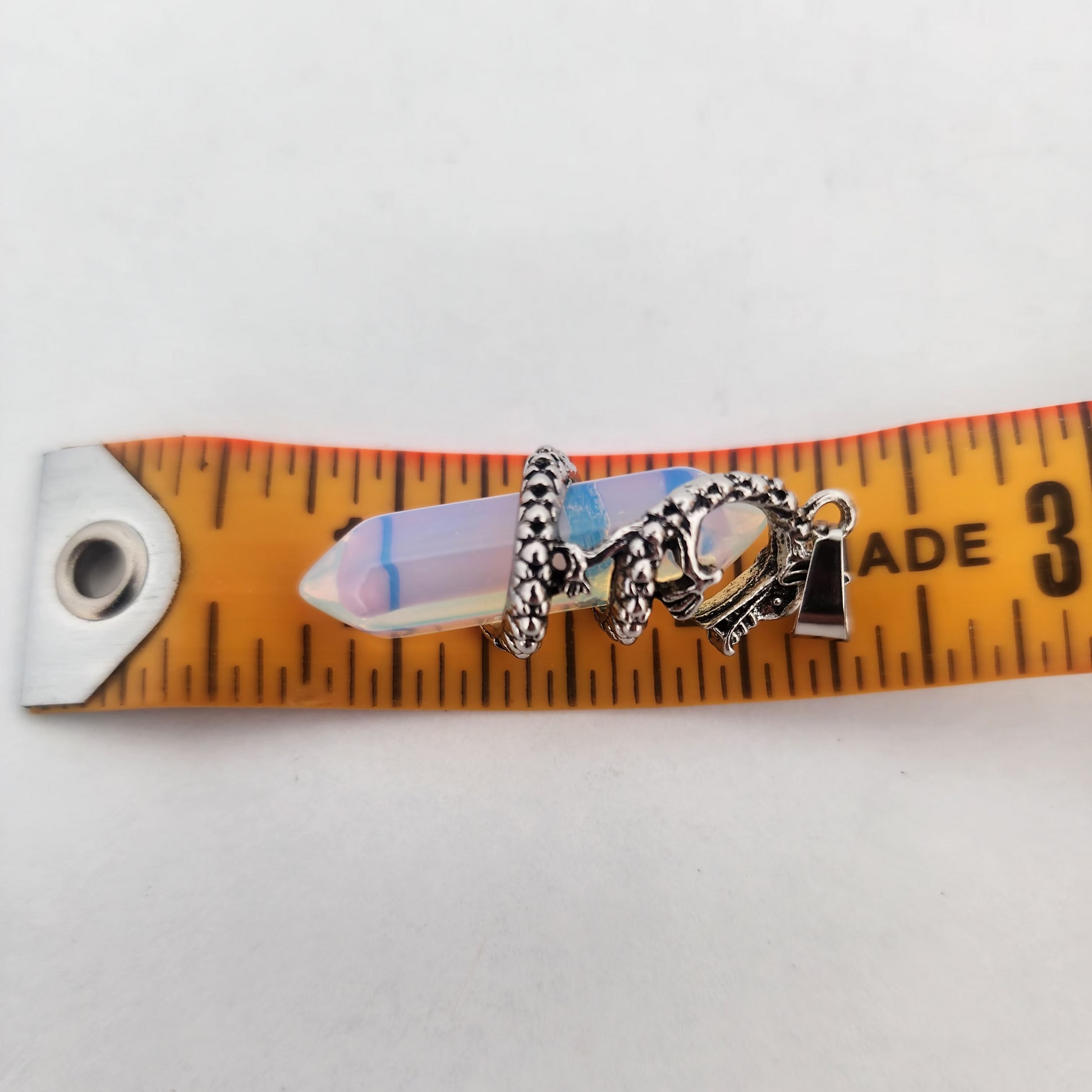 Bracelet with charms on a ruler for size reference
