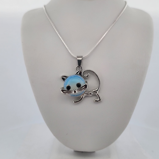 Cat-shaped pendant on a necklace displayed on a gray bust