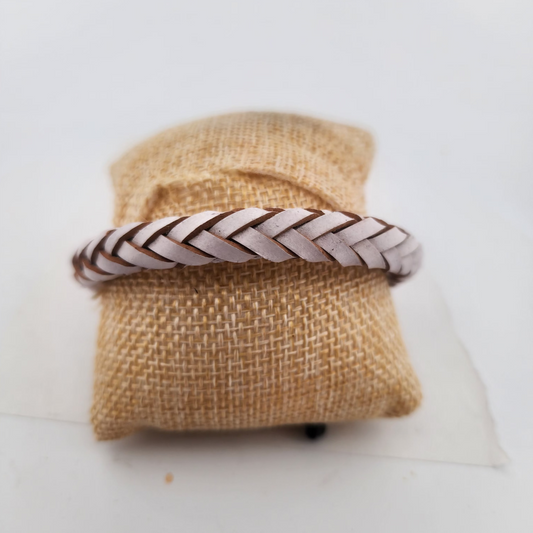 Braided bracelet on a burlap bag with a white background