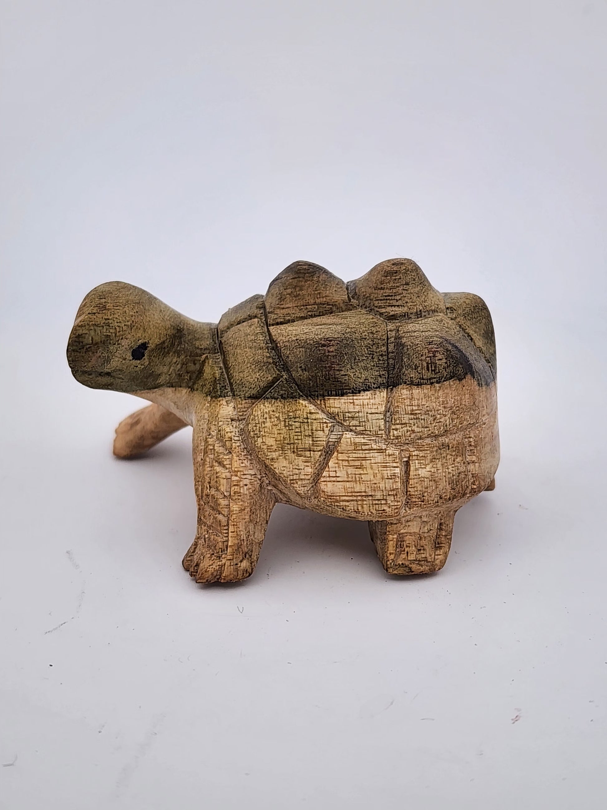 Wooden turtle figurine on a white background