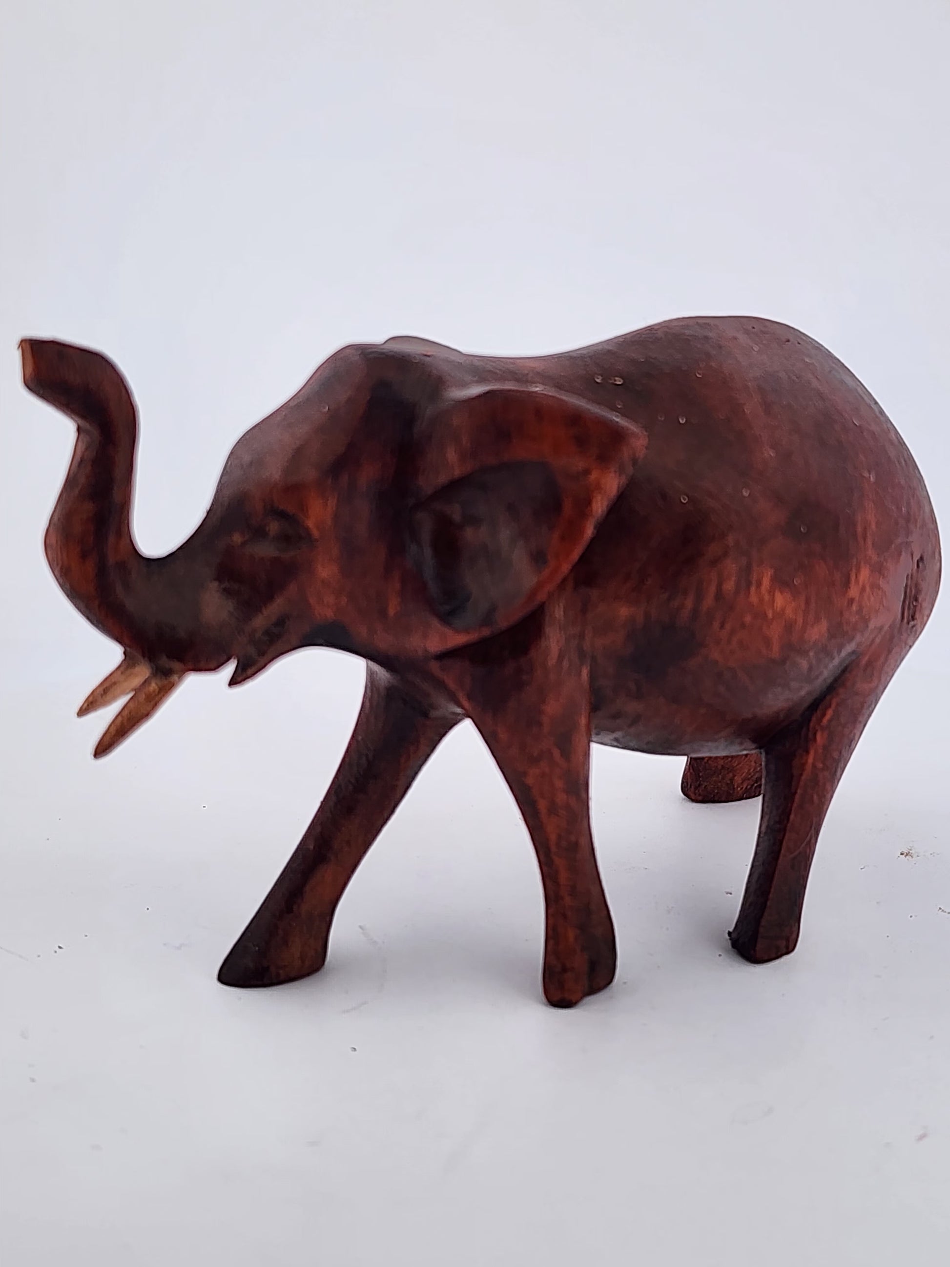 Wooden elephant figurine on a white background