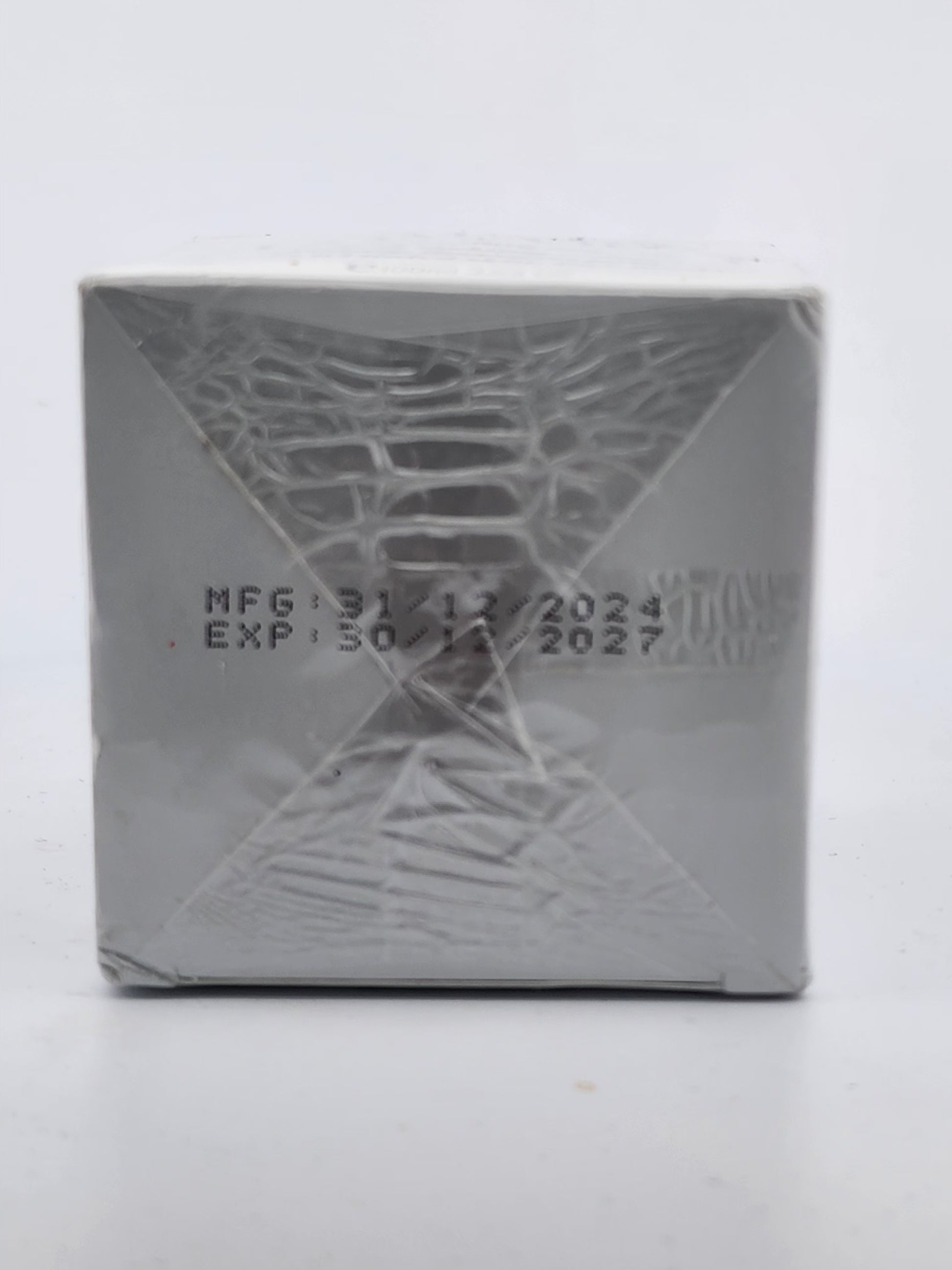 Silver product packaging with embossed design and text on a white background