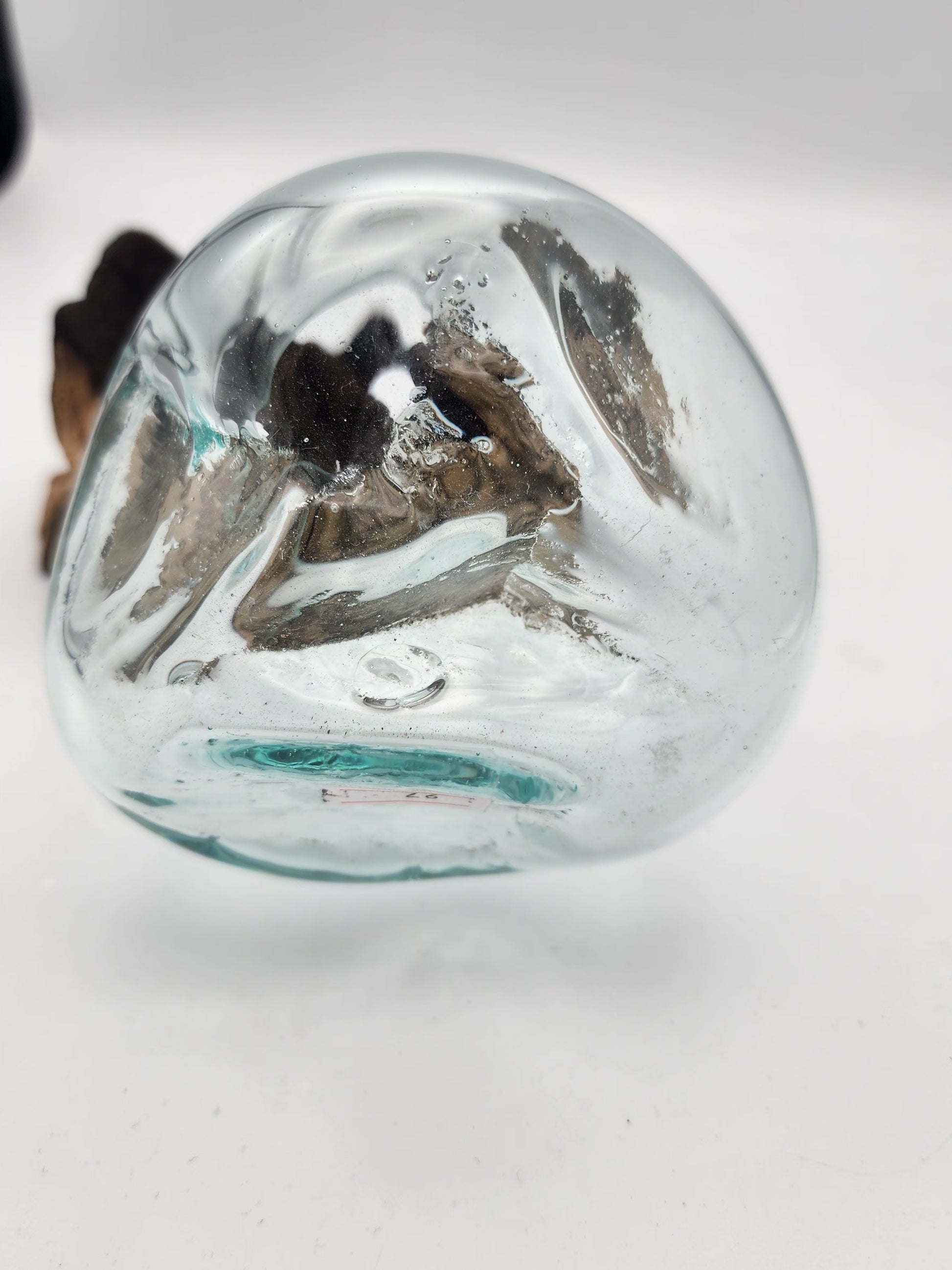 Clear glass sphere with a textured surface on a white background