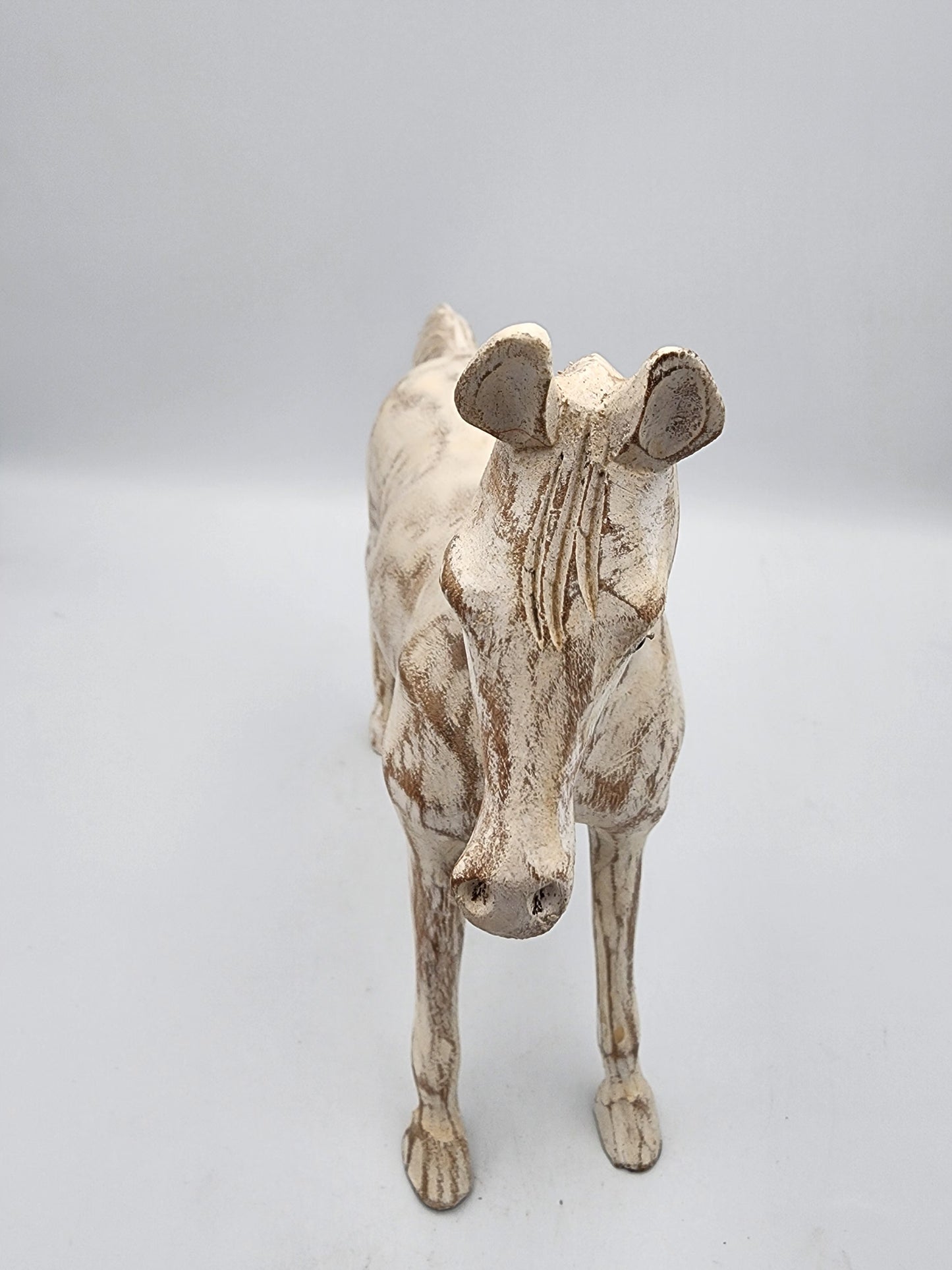 Ceramic cow figurine on a light gray background